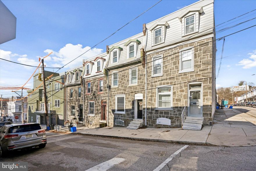 Welcome to this  Manayunk 4 bedroom, 1.5 bath stone front  home that blends classic charm with modern convenience.  Enter through the vestibule entrance which invites you into the spacious living room that features hardwood floors, slate faux fireplace, ceiling fan and opens to the dining room.  Off the dining room you will find the Oak-Cabinet eat-in-kitchen with subway tile backsplash, porcelain tile floor, recessed lighting and stainless steel appliances including the 5 burner gas stove with griddle.  The rear mud room has porcelain tile floors, a convenient first floor powder room and sliders to the fenced rear yard.  The second level of this home features original hardwood floors, office with exposed brick wall and recessed lighting, full porcelain tile hall bathroom, and two spacious bedrooms with great natural lighting and ample closet space (one with a walk-in closet!).  Two additional large bedrooms and an extra hall closet are located on the third level of this home.  High ceilings, deep window sills and high baseboards are throughout and exude character and charm.  Other great features include NEW HVAC, New windows, Central Air, full unfinished basement, a fully fenced yard and is conveniently located near parks, shops, public transportation including Wissahickon Train Station, restaurants and more! Talk about Location, Location, Location