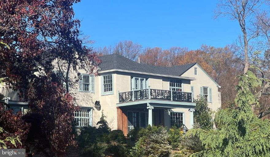 Set on nearly five acres in the heart of the Main Line, this extraordinary 4 bedroom, 3 full and 1 half bath single family residence blends historic European craftsmanship with thoughtful modern upgrades. Originally constructed in 1930, the home offers just over 5,000 square feet of refined living space, surrounded by mature landscaping and one of the finest private conifer collections on the East Coast.

Throughout the home, hand selected, period appropriate Farrow & Ball paint colors complement rare architectural elements and museum quality finishes. Cuban mahogany and walnut paneling sourced from the renowned J.P. Morgan Library grace the sunroom, ballroom, library, dining room, stairwell and primary suite, creating a sense of timeless elegance and historical significance. The sunroom features a hidden library, adding a layer of intrigue and charm.

The kitchen was fully renovated in 2023 with custom cabinetry, a farmhouse sink, and high end appliances including an LG wall oven, LG convection microwave, LG gas cooktop, and a KitchenAid refrigerator.  A beautifully detailed mudroom showcases 16th-century English paneling from the historic Guildford Estate, originally owned by industrialist George W. Elkins, with Tudor architectural elements imported from England and meticulously reassembled by European craftsmen.

The primary suite continues the home’s remarkable story, featuring J.P. Morgan Library paneling in the bedroom and Guildford Estate paneling in the dressing room; elements that took nearly a decade to complete in their original installation. Throughout the home, exquisite 19th century doors and doorways further enhance its architectural authenticity.

Recent upgrades include new HVAC systems with programmable thermostats, plumbing and mechanical improvements by Haller Enterprises, a new septic tank, a 50-gallon water heater, and a new roof and gutters installed in October 2022. A full basement, attached garage, newly installed carport and patio provide both functionality and convenience. 

The grounds are equally impressive, featuring an exceptional collection of mature and rare trees, including Japanese maples, cryptomeria, weeping conifers, Serbian spruce, beech, and many others; creating a private arboretum like setting.

A rare opportunity to own a property where architectural history, craftsmanship, and modern comfort converge in one of the Main Line’s most desirable locations with low taxes. Also, listed as Land, possible subdivision allowed.