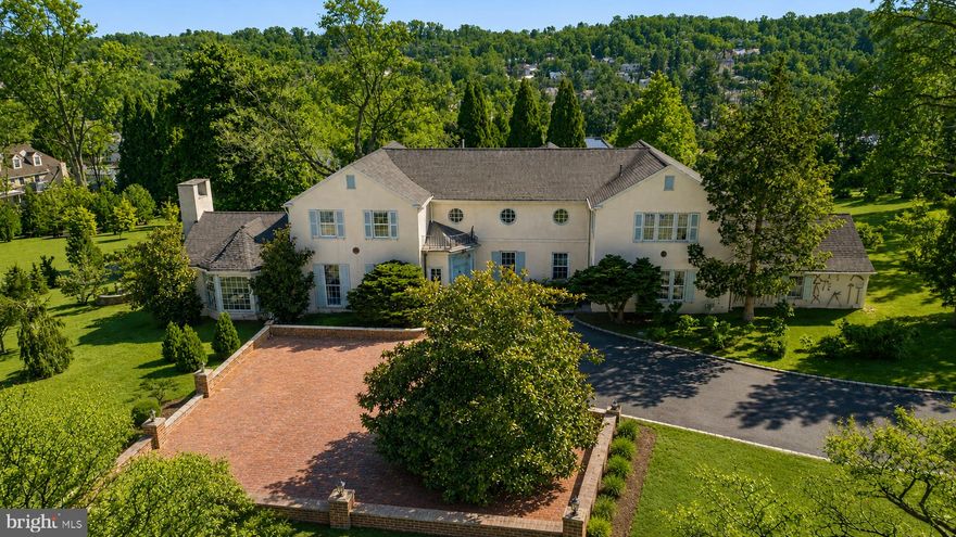 Set on nearly five acres in the heart of the Main Line, this notable 4 bedroom, 3 full and 1 half bath single family residence blends historic European craftsmanship with thoughtful modern upgrades. Originally constructed in 1930, the home offers just over 5,000 square feet of refined living space, surrounded by mature landscaping and one of the finest private conifer collections on the East Coast.

Throughout the home, hand selected, period appropriate Farrow & Ball paint colors complement rare architectural elements and museum quality finishes. Cuban mahogany and walnut paneling sourced from the renowned J.P. Morgan Library grace the sunroom, ballroom, library, dining room, stairwell and primary suite, creating a sense of timeless elegance and historical significance. The sunroom features a hidden library, adding a layer of intrigue and charm.

The kitchen was fully renovated in 2023 with custom cabinetry, a farmhouse sink, and high end appliances including an LG wall oven, LG convection microwave, LG gas cooktop, and a KitchenAid refrigerator.  A beautifully detailed mudroom showcases 16th-century English paneling from the historic Guildford Estate, originally owned by industrialist George W. Elkins, with Tudor architectural elements imported from England and meticulously reassembled by European craftsmen.

The primary suite continues the home’s remarkable story, featuring J.P. Morgan Library paneling in the bedroom and Guildford Estate paneling in the dressing room; elements that took nearly a decade to complete in their original installation. Throughout the home, exquisite 19th century doors and doorways further enhance its architectural authenticity.

Recent upgrades include new HVAC systems with programmable thermostats, plumbing and mechanical improvements by Haller Enterprises, a new septic tank, a 50-gallon water heater, and a new roof and gutters installed in October 2022. A full basement with laundry, attached garage, newly installed carport and patio provide both functionality and convenience. 

The grounds are equally impressive, featuring an exceptional collection of mature and rare trees, including Japanese maples, cryptomeria, weeping conifers, Serbian spruce, beech, and many others; creating a private arboretum like setting.

A rare opportunity to own a property where architectural history, craftsmanship, and modern comfort converge in one of the Main Line’s most desirable locations with low taxes.  Please note also listed as Land, possible subdivision allowed.  Watch the video tour to fully experience the property.
