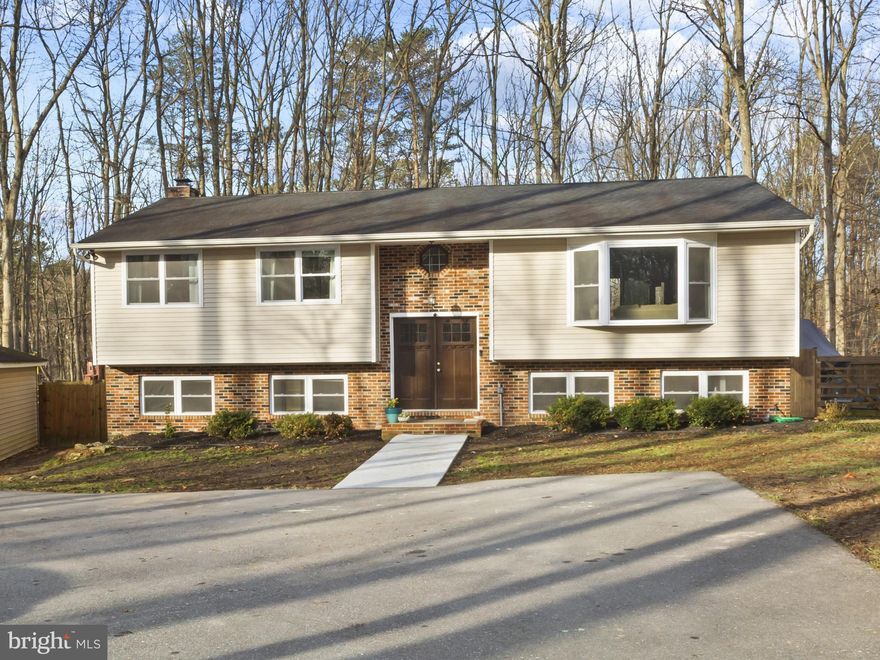 Completely renovated and move-in ready! This beautiful, single-family home is perfectly situated on a private, over 2-acre lot offering lots of space to roam! Updated from top to bottom this home offers newer double-hung windows and sliders, newer HVAC, fresh paint, new, oversized, composite deck, newer recessed lighting, updated baths, and lots of storage space! Large living room with beautiful, bay window allowing lots of natural light! Remodeled kitchen with granite counters, custom island, stainless steel appliances and tile backsplash! Dining room with sliders to a huge, custom-built deck - ideal for entertaining or simply enjoying the peaceful setting! Oversized, primary bedroom offers sliders to a balcony for additional serene views! Thoughtfully, redesigned primary bath features a corner soaking tub with jets and walk-in shower! Two additional bedrooms have lots of closet space and the hall bath has been tastefully renovated! The open foyer area leads to a fabulous family room and a spacious game room with cozy fireplace with new luxury vinyl plank floors! This level also features another bedroom - perfect for guests, extended family or a private home office, an updated full bath, an expansive laundry room with laundry tub and utilities, water treatment system, additional refrigerator and rear exit to backyard! Rarely do you find this type of home setting - tranquil surroundings, yet minutes from major highways, public transportation, shopping, dining and everyday amenities! It is truly the ideal balance of privacy and accessibility - giving the best of both worlds! No HOA! Easy access to DC, Annapolis, Baltimore, Fort Meade, and NSA! Show and sell! A 10+++