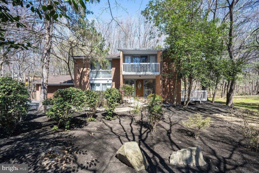 New Price Improvement. Great buy with over 5,100 sq ft in the Whitman district. Updated sun-filled contemporary home in tranquil, tree-lined Persimmon Tree.  This 6-bedroom 4-bath house  has been fully updated and offers an open floor plan that’s perfect for entertaining.
    The home has ample spaces for indoor and outdoor enjoyment, including a dining room and living room with floor-to-ceiling windows, and a large deck that overlooks the serene wooded lot.  A beautifully updated kitchen features a cozy banquette and side deck for enjoying a morning coffee. With stainless steel appliances, quartz countertops and plenty of storage, it’s the ideal gourmet chef's kitchen. The large family room, complete with a fireplace and modern built in bar, leads to a sunroom with backyard access and a basketball court.
    The primary bedroom has a wall of windows, private deck and large updated walk-in closet, as well as a recently-renovated primary bathroom. There are 3 additional bedrooms with generous closets upstairs, plus an updated modern hall bath, and office space with built ins.
    On the main floor, there is a sunny bedroom and gorgeous new full bath. The updated lower-level basement holds 2 additional bedrooms, an updated full bath, plenty of space for a home gym or rec room, and a 2-car garage.  This home is move-in ready with hardwood floors and freshly-painted exterior.  Walk to the C&O canal & Cabin John restaurants. Just minutes to downtown Bethesda, and an easy commute to MD, DC and VA.