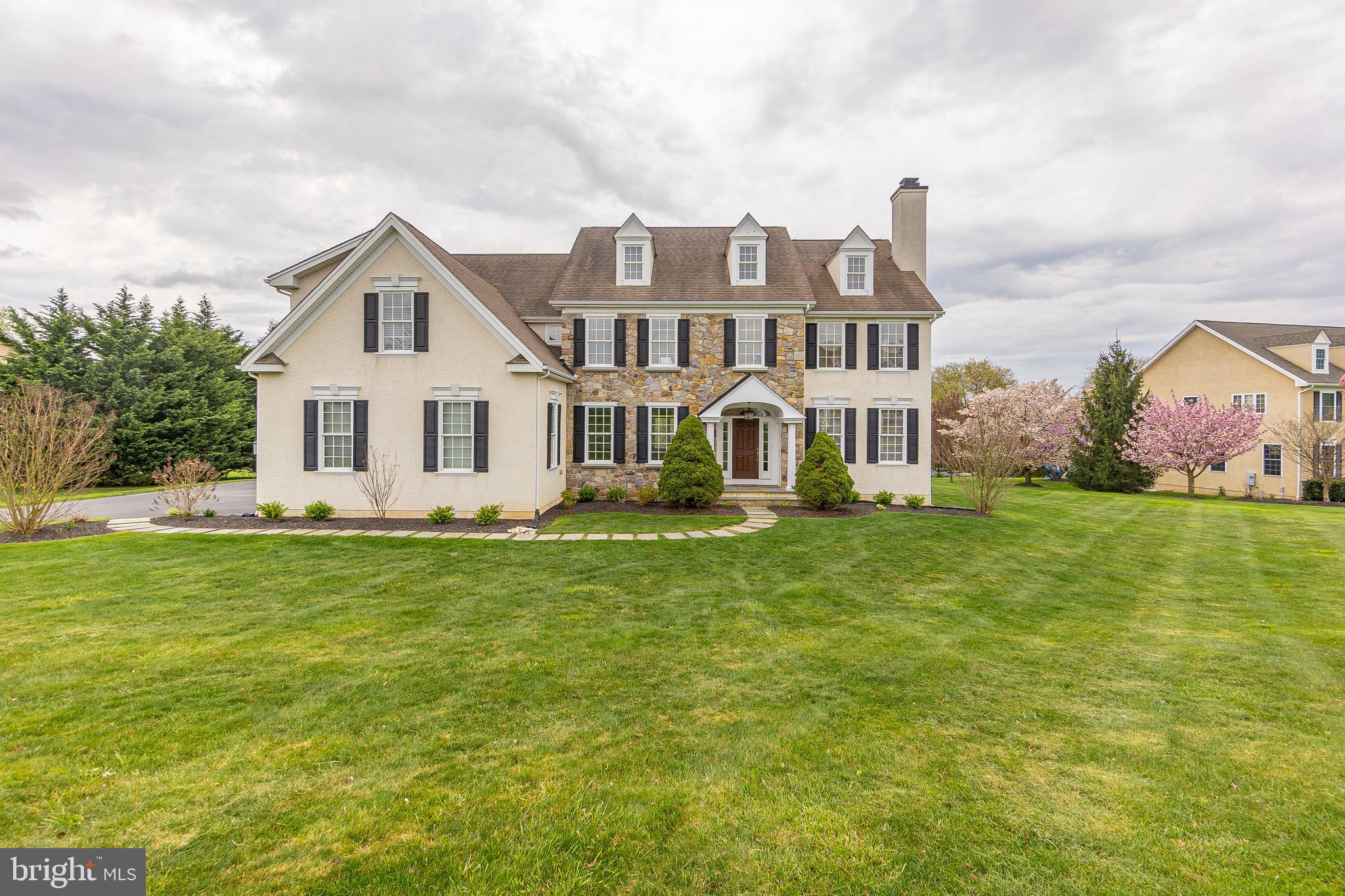 Welcome to 26 Cumberland Drive, a stunning 5-bedroom, 5 full bath, 2 half bath residence nestled in the prestigious Meadows neighborhood of Downingtown. Boasting an expansive 1-acre lot, this property offers luxury living at its finest. Upon entry, you are greeted by the foyer adorned with crown molding and gleaming hardwood floors that seamlessly flow into the spacious dining room. The inviting living room features a cozy fireplace, crown molding and access to a private office with recessed lighting, ideal for remote work or quiet study sessions. The beautiful kitchen features hardwood floors, custom cabinets, a double oven, granite countertops, a large island, and a convenient walk-in pantry. Adjacent, the breakfast room offers a charming tray ceiling and sliding glass door to the deck, perfect for al fresco dining and relaxation. Relax and unwind in the comfortable family room, highlighted by a tray ceiling and a striking brick fireplace, perfect for cozy evenings with loved ones. A practical mudroom provides access to the attached 3-car garage, ensuring convenience and functionality for everyday living. Additionally, two half baths on the main level offer added convenience. The upper level primary bedroom awaits with a luxurious tray ceiling, dual walk-in closets, a cozy sitting area, and a spa-like en-suite bathroom featuring tile floors, a shower stall, a soaking tub, and a double vanity. Two more generously sized bedrooms each boast their own en-suite bathrooms, with an additional two bedrooms sharing a convenient jack-n-jill bathroom. Completing the upper level is a convenient laundry room, adding ease to daily chores. The finished basement offers additional living space, perfect for entertaining or relaxation, with a large entertainment room and a full bathroom. Ample storage space is provided in the large storage room, ensuring organization and functionality. Situated close to local parks and the award winning Downingtown Area School District and STEM academy. This exceptional residence offers a coveted blend of luxury, comfort, and convenience. Don't miss your chance to make 26 Cumberland Drive your new home!