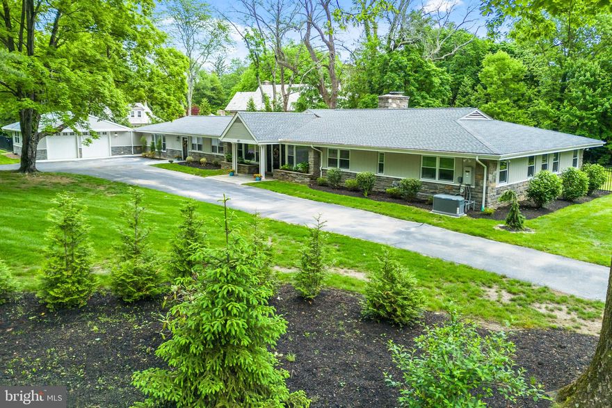 From the inviting circular driveway to the beautiful rear paver patio, this exquisite custom home offers an unparalleled blend of luxury and functionality across nearly 2 acres of lush landscape. Boasting a spacious layout spanning 4 bedrooms and 4 full bathrooms within its 4,475 square feet, this property epitomizes contemporary elegance fused with timeless charm, catering effortlessly to both grand gatherings and day-to-day relaxation. Stepping into the foyer, you are immediately greeted by soaring cathedral ceilings adorned with rustic wood beams and intricate architectural accents. The expansive Great Room captivates with a striking stone wall housing a wood-burning fireplace, complemented by built-in shelving, towering 12-foot windows bathing the space in natural light, and a cozy window seat offering serene views of the backyard oasis. Seamlessly connected to the dining area, the chef-inspired Kitchen is a culinary haven, featuring a sizable center island with bar-height seating, custom 42-inch cabinets, subway tile backsplash, premium stainless-steel appliances, a generous walk-in pantry, and an area for dining. Adjacent to the Kitchen lies the bright Solarium, accessible through French doors from both the Kitchen and Great Room, boasting porcelain tile flooring, skylights, built-in shelving, and sliding doors opening onto the rear patio, creating an idyllic indoor-outdoor flow. The thoughtfully designed floor plan further encompasses a spacious Family Room, a full bathroom, laundry room, large storage room, and mudroom with custom storage that leads to the attached two-car garage. Nestled on the opposite wing are the tranquil sleeping quarters, comprising of two well-appointed bedrooms sharing a Jack-n-Jill bathroom with dual vanity and tub shower, and an additional gracious bedroom with and a hall bathroom featuring a vanity and stall shower. You will also find an owner's suite replete with a vast walk-in closet with custom shelving,  and a sumptuous bathroom boasting a marble vanity, tile flooring, and a spa-like shower. Noteworthy amenities include whole house generator, custom lighting, crown molding, gleaming wood floors, an upgraded electrical package, and a two-zone HVAC system, new skylights, and a partially replaced roof.  Situated on a sprawling 1.98-acre lot within proximity to Merion Golf Club, Haverford Reserve, prestigious schools & universities, upscale shopping, dining destinations, and major thoroughfares, this impeccable residence offers a harmonious fusion of prime location and contemporary luxury living, presenting an unmissable opportunity for buyers seeking the epitome of move-in ready sophistication.  This property & home must be toured to appreciate all that it has to offer- schedule your tour today!