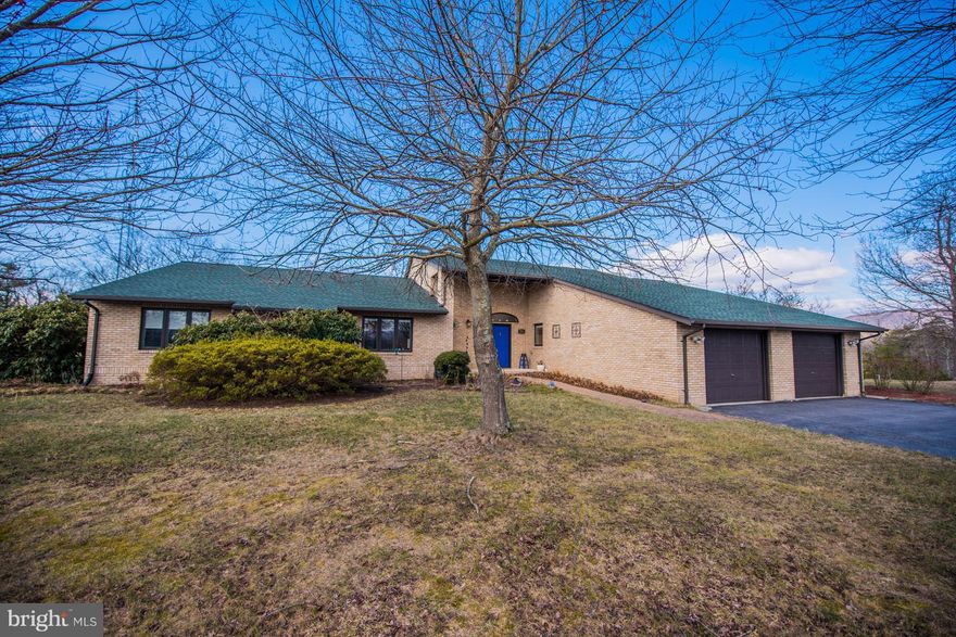 Gorgeous contemporary rancher with all brick construction, 26+ acres, Lake Access community. This home was remodeled in 2010, has hardwoods and tile throughout the sprawling 3000+ main level.  Master en suite boasts bidet and sauna to pamper the owners. Large closets, sunken living room, library, separate dining room. Gourmet kitchen with upgraded appliances and pantry room. Artesian well on lot.