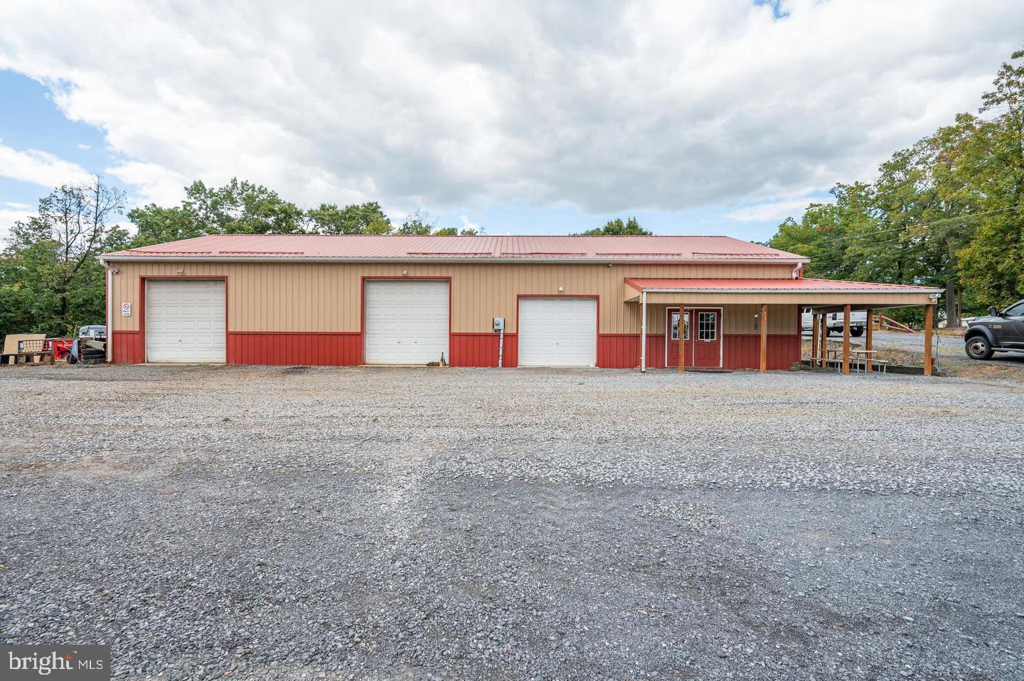This property on Route 51 between Inwood and Charles Town presents an exceptional opportunity for businesses seeking prime visibility and ample space. Boasting a spacious 40X80 building with multiple offices, two bathrooms, and a boardroom, it offers the ideal setting for a wide range of ventures. Whether you envision a retail showroom, a distribution center, a manufacturing facility, or even a creative studio, this property provides the infrastructure and flexibility to accommodate your needs.
The layout, including the large shop area that can be customized to suit your requirements, opens up possibilities for various operations, such as warehousing, light industrial work, or creative workshops. The generous parking area caters to customers and allows for easy logistics and employee convenience. Additionally, the potential for expansion means you can scale your business as it grows, ensuring long-term viability.
With its strategic location and adaptable design, this property offers endless possibilities for businesses across diverse industries. Whether you're an entrepreneur launching a startup or an established company seeking to expand, this property provides the foundation for your success. The tenant is responsible for all expenses including taxes and insurance. Triple Net Lease