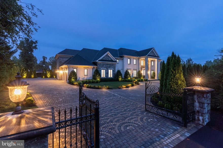 Introducing 1181 Ballantrae Lane—a modern manor inspired by the great estates of Europe and set behind private wrought-iron gates in the prestigious enclave of Langley Farms. Completed in 2018, this one-of-a-kind property stands as one of the last grand estates built in historic Ballantrae, a neighborhood long favored by ambassadors, dignitaries, and captains of industry.

From the moment you enter the 25-foot domed foyer, the home reveals a level of craftsmanship seldom seen today. Custom ironwork, Murano chandeliers, and rich five-inch white oak floors set an immediate tone of timeless elegance. Floor-to-ceiling windows draw in natural light and frame the manicured garden plazas and Versailles-inspired pool beyond.

Designed for both intimate living and large-scale entertaining, the residence features an embassy-sized dining room, formal salons, and a chef’s show kitchen crafted in Italy by Bordignon Camillo. A second, fully outfitted caterer’s kitchen with UNICA cabinetry provides seamless support for events of any size.

On the upper level, four luxurious bedroom suites offer spa-style baths and generous wardrobe spaces. The primary suite serves as a private sanctuary, complete with dual dressing rooms, a lavish bath, a serene sitting area, and direct access to a terrace overlooking the grounds.

The estate’s lower level is an entertainer’s paradise. Here, a circular party room, club lounge, cinema, fitness center, sauna, and a professionally designed wine cellar come together to create a world-class leisure environment—beautifully finished with imported Versace ceramic flooring.

Outside, the property unfolds into a secluded resort setting. The expansive pool court, heated spa, pavilions, and illuminated water features create an atmosphere of tranquility and grandeur. With a four-car garage and a driveway accommodating up to thirty vehicles, the estate is as functional as it is magnificent.

Situated at the corner of Ballantrae Lane and Dolley Madison Boulevard, this home occupies a rare and distinguished position just minutes from Washington, D.C. With its meticulous craftsmanship, European inspiration, and modern amenities, 1181 Ballantrae Lane is more than a residence—it is a legacy estate of lasting significance.