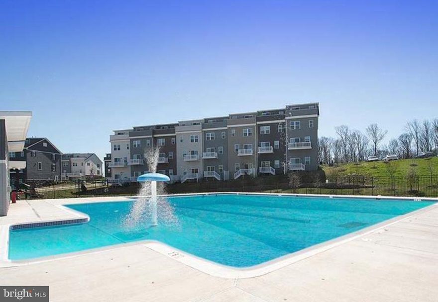 Experience luxury living at its finest in this almost new, second floor, corner unit boasting breathtaking sunset views of the distant Catoctin and Sugarloaf mountains. Designed with a bank of windows, this residence offers vistas from every front corner for the condo, ensuring a picturesque backdrop whether you're cooking, dining, relaxing, or entertaining. The open concept layout seamlessly connects the kitchen, dining area, and living room, creating an ideal space for gatherings and everyday living. The gorgeous kitchen features white quartz countertops, stainless steel appliances, a spacious pantry, and an inviting island perfect for entertaining. 
The main bedroom has ample space with a walk-in closet and private bath, while the second bedroom at the opposite end of the condo offers privacy and convenience with its own hall bathroom. Step outside to relax and unwind on your private composite deck. Modern and safety amenities include elevator access.
Card entry for your garage parking. 
Take advantage of the community's basketball court, pickleball court, tot lot and refreshing pool, just steps away from your front lobby door. 
Not only does this condominium offer a luxurious living space, but it also provides easy access to a plethora of entertainment options and recreational activities, ensuring there's something for everyone to enjoy nearby. 
Walking enthusiasts will appreciate the proximity to the nearby Harris Teeter shopping center and a variety of restaurants. Target and Costco are also conveniently located just around the corner. For those seeking excitement, explore entertainment options at Top Golf, iFLY indoor skydiving, or enjoy outdoor activities at Claude Moore or the indoor facility that includes indoor pool, basketball courts & gym. 
Fulfill your shopping desires at Dulles Mall, Reston Town Center, and Tysons Corner, where you'll find an array of stores catering to every taste and style. Nature lovers can immerse themselves in the beauty of Great Falls Park, where hiking trails and stunning waterfalls await. Close proximity to commuter Route 7 and 286 ensures easy access to transportation hubs and major thoroughfares.