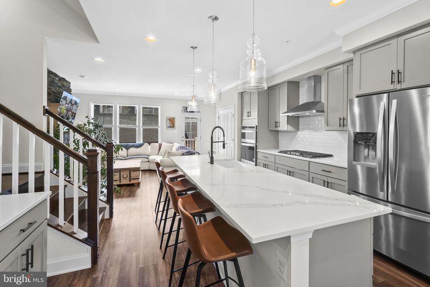 Welcome to 905 Holden Road, an exceptional Ashby model townhome in the highly sought-after EastChurch community. This is not just a house; it's a statement of style and quality craftsmanship, perfected for modern living.

Step inside and immediately feel the sense of space and light. The main level's open floor plan, with its 9-foot ceilings and hardwood floors, is built for effortless entertaining. The half bath, completely renovated, is a stylish detail, but the true centerpiece is the gourmet kitchen. It's a chef's delight, complete with a massive quartz island, stainless steel appliances, and a gas range. The kitchen seamlessly connects to the living area, which is highlighted by a cozy gas fireplace—the ideal spot for relaxation.

Upstairs, the bedrooms are tranquil retreats. The freshly painted primary suite features elegant crown molding and two expansive custom closets with built-ins, while the secondary bedrooms have been finished with fresh paint, new flooring, and elegant crown molding. The upper-level laundry makes daily chores a breeze.

The fully finished basement is a game-changer. It offers a comfortable recreation room and a versatile private bedroom, perfect for guests or a dedicated home office. The spa-like bathroom is a standout, recently renovated top to bottom, boasting a custom glass shower, a modern vanity, and new tile. Best of all, a rare walk-out with full-sized windows floods the space with natural light, making it feel every bit as open and inviting as the main level.

Every detail, from the expansive 2025 renovations to the home's superb location, confirms its value. EastChurch offers a true "lock-and-go" lifestyle, with a community pool, recreation center, and HOA services that handle maintenance—all just a short stroll from the history and culture of downtown Frederick. This home is ready to impress. Mortgage savings may be available for buyers of this listing.