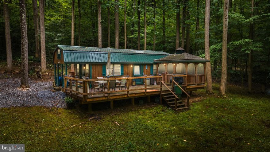 Imagine the possibilities for this 18 acres of wooded land with gated access just off Spruce Run Road near Myersville, MD.  Four of the five lots passed a previous perc test.  Split them up for development or keep this entire secluded haven all to yourself.  Some of the mature hardwoods have been marked for potential harvesting and a trout stream (part of the Spruce Run) meanders along one edge of the property.  A deer hunter's dream come true,  this property also features three tree stands, two blinds, and two automatic feeders.  The 28x11.5 insulated sportsman's cabin is a non-permanent structure that will not disappoint and it comes mostly furnished.  It is equipped with a gas generator for electricity, a propane refrigerator and stove, and an above ground water catchment system for non-potable water.  An on demand water heater for the shower makes you forget you're roughing it.  There is also an outdoor portable toilet, a large deck and a screened gazebo where you can relax, unplug, and let the gentle voice of Spruce Run wash the previous workweek's worries away.  A well packed gravel parking area keeps you out of the mud and a 10x16 storage shed keeps your toys out of the weather.  This may be the getaway spot that you just can't do without.  So, come check it out—you'll be in Love!