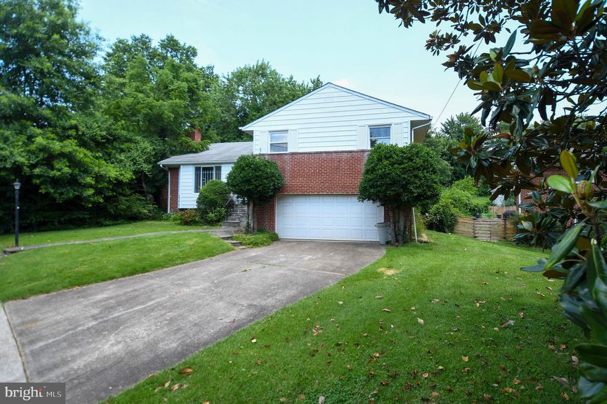 Welcome to this beautifully updated 4-bedroom, 2-bathroom brick home offering timeless charm and modern upgrades. This stately 4-level split features an attached 2-car garage and sits on a picturesque lot in a sought-after neighborhood. Step inside to brand-new luxury vinyl plank flooring and fresh designer paint throughout. The completely renovated kitchen is a showstopper, boasting all-new stainless-steel appliances, sleek quartz countertops, and a stylish backsplash. The formal living room, accessible via a charming covered alcove, flows effortlessly into a separate dining room—perfect for entertaining. A spacious den just off the kitchen overlooks the beautifully landscaped backyard and dual patios, offering the ideal setting for indoor-outdoor living. The skylit hallway and foyer fill the home with abundant natural light—no need to turn on the lights during the day! Upstairs, the primary bedroom features a walk-in closet, and the hallway bathroom has been upgraded with a new double-sink vanity. The finished lower level includes the fourth bedroom with a private rear entrance—ideal for guests, an office, or rental potential. The lowest level offers a large laundry/utility room and additional space with expansion possibilities. Prime Location: Just a few blocks from Evans Parkway Neighborhood Park, one mile to Wheaton Metro, shopping, and dining, and minutes from I-495 and Holy Cross Hospital. This is a home that truly has it all—space, style, and unbeatable convenience.