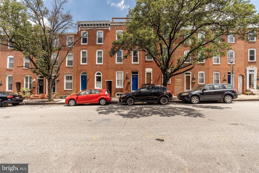 Newly refreshed and picture perfect! Stylishly neutral decor shows off gleaming wood floors in LR and a spacious cook's Kit w granite counters and stainless applcs. Brand new carpet in all BRs! Convenient 2nd level Laundry. 3rd floor is entire Master Suite featuring a private balcony, walk-in closet & large MBath. Independent staircase  access from 3rd floor to roof deck that boasts dramatic 360-degree panoramic views of the city skyline and Harbor. Very easy private parking