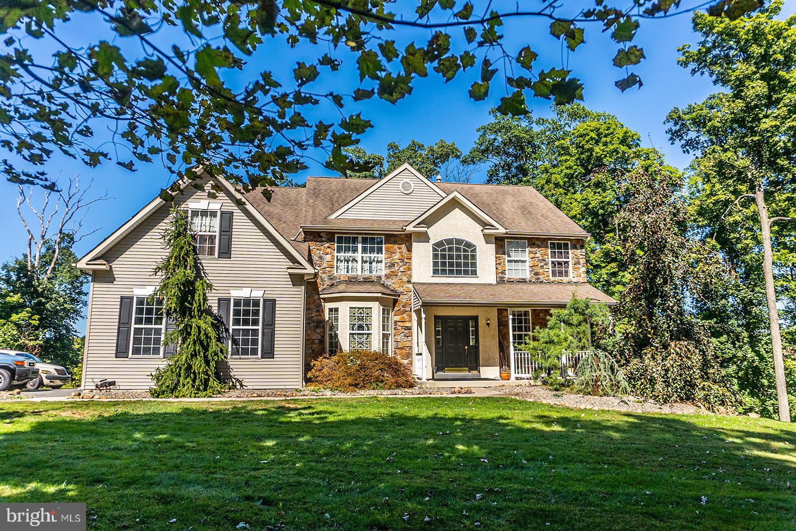This exceptional home sits on a wonderfully secluded 1.8 acre lot and is in the sought after development of Bella Vista but WITHOUT the HOA fees!  Enjoy the outstanding winter views over the golf course and Club House and, in the summer, the privacy afforded by the trees, especially while poolside at your 4' deep inground pool.  Once inside, one of the many unique features is the soaring two story, two sided stone fireplace that can be appreciated in the family room, kitchen and the oversized informal dining area. The kitchen has ample custom cabinets, an island workspace.and opens to the breakfast area with doors to the deck. From the deck there is a custom spiral stairway to the lower patio..  The huge family room has a wall of windows and access to the charming side deck.  Leading off the dramatic two story foyer with its split stairway are the formal Living Room and Dining Room. (note the carved decorative valances and the decorative fireplace and mantle in the Living Room will not stay).  The main floor has an office/bedroom suite with a powder room and separate shower stall.  Adjoining this area is the huge multi purpose laundry, mudroom, walk in pantry. This space was created in one of the garage bays, the framing for which is still intact and could easily be converted back to its original use.  On the second floor there are two bedrooms that share a hall bath at one end of the hallway which overlooks both the living areas and foyer below. At the other end is an additional bedroom and the magnificent main suite.  The original 5 BR floor plan was modified to provide a large sitting area, an oversized walk-in closet and the bathroom with its two person corner jetted tub (with inline heating system) and separate stall shower. The basement, while unfinished, has direct at grade access to the backyard and the pool. There is ample parking for guests. Another unusual feature is that the shed is fully insulated! This home is truly one of a kind.