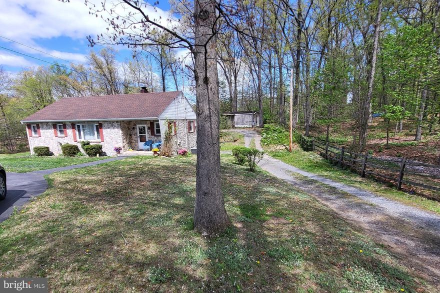 "Picturesque Setting"  Offering single family home w/rentable mobile home for extended family or income!  3 to 4 bedroom home has additional bath, bedroom & kitchenette in semi-finished basement (potential in-law suite?).  Wood floors and newer LVP in kitchen!  Room for everyone and their hobbies.  4 car garage space/ workshop & shed!    Public water & sewer.  Also, 1993 2 bedroom mobile home at rear of lot.  This has been a nice arrangement w/family members- Now owner retiring.    All situated on a 1.4 acre country lot!