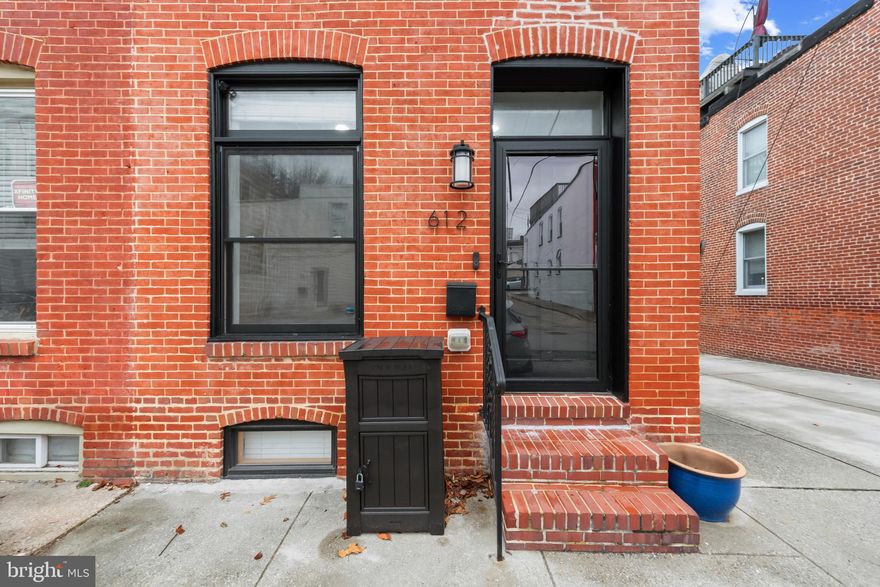 Beautifully updated and thoughtfully maintained, this end-unit Canton rowhome offers both charm and everyday convenience. Enjoy the benefit of off-street parking with easy alley and side-street access.
Step inside to an inviting main level with an open flow from the living room to the spacious kitchen. The oversized island seats four comfortably, allowing you to dine at the counter or gather around a separate table. Stainless steel appliances, pristine countertops, pendant lights, and under-cabinet lighting create a bright, modern workspace, complemented by abundant cabinetry and a built-in wine refrigerator.
Upstairs, the primary bedroom is the perfect space to unwind with its expansive walk-in closet and private bath featuring a dual-sink vanity. The finished lower level provides two additional bedrooms and a full bath—ideal for guests, office space, or a home gym. A rooftop deck crowns the home, offering a stunning view of the Baltimore skyline—perfect for relaxing or entertaining. Situated just a few blocks southeast of Patterson Park, this location also provides quick access to Routes 95 and 895, downtown, and the waterfront along Boston Street. There are still 2-3 years remaining on the CHAP Tax Credit.