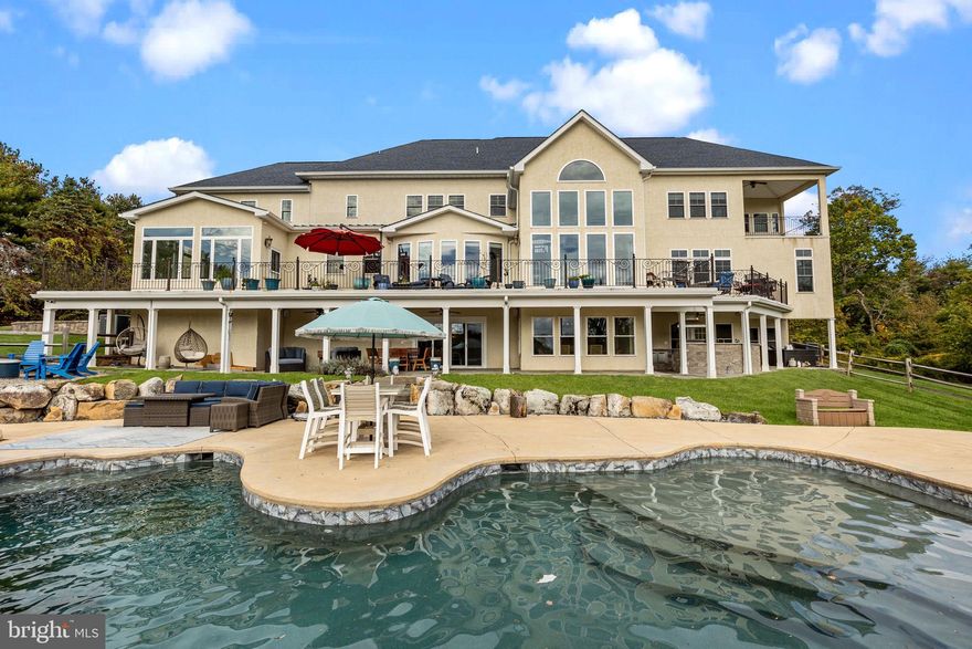 Custom Resort-Style Estate with Breathtaking Valley Views in Council Rock North School District
Indulge in an unparalleled lifestyle within this custom-built, 5-bedroom, 5.5-bath single-family home, situated on a serene 5.40-acre lot with panoramic valley views. Enter the grand, two-story stone foyer and be greeted by sheer elegance and exquisite design. This sophisticated estate seamlessly blends luxurious indoor living with a magnificent resort-style outdoor oasis, creating the ultimate retreat for discerning buyers.
The heart of the home is the chef's kitchen, featuring top-of-the-line appliances, including a Sub-Zero refrigerator/freezer, an Italian ILVE eight-burner gas range, a Miele dishwasher, and a walk-in pantry. Beyond the kitchen, you will find: A private, first-floor home office , A bright sunroom overlooking the landscaped backyard. The second floor features four large bedrooms, each with its own private bath and walk-in closets, plus a delightful secret bonus room currently set up as a playroom. Throughout the home, enjoy a built-in speaker and central vacuum system. This home features a convenient first and second-floor laundry rooms, with a dedicated dog shower on the main level.
The newly finished basement elevates entertainment to new heights with a custom live-edge wet bar and kegerator, a temperature-controlled wine room, and a padded floor gym. Step directly from the basement into your outdoor paradise, which features a spectacular saltwater pool complete with a waterfall, waterslide, and enchanting grotto. The bluestone patio and covered deck with a built-in custom grill and second kegerator offer year-round entertainment possibilities. The property also includes a secure custom chicken coop.
 This extraordinary property provides the perfect combination of privacy, luxury, and entertainment for grand celebrations or quiet moments alike. All of this is located in the highly-acclaimed Council Rock North School district. This exceptional opportunity  won't last long—schedule your private tour today.
This home is withing a short drive to either Trenton or Doylestown Airports.  NYC  and Philadelphia are also with in a commutable distance.