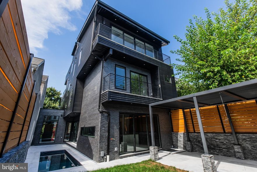 Welcome to the epitome of luxury living at this exceptional Manayunk residence, where sophistication meets contemporary design in a breathtaking display of artistry. Nestled on a double-wide lot, this architectural masterpiece boasts 20-foot high ceilings, a spacious two-car garage, and opulent finishes that define grandeur.

As you step inside, the entrance gallery immediately draws your gaze through a large glass window, seamlessly connecting you to your outdoor oasis and inviting pool. The entrance gallery unfolds into an expansive living area adorned with an electric fireplace wall and massive windows that flood the space with natural light. The living area offers an open layout floor plan, with a large living room space that seamlessly leads into the dining table area and the kitchen, creating an ideal setting for both relaxation and entertainment. The living space transitions to the outdoors through 12-foot sliding glass doors, leading to your private oasis—a verdant garden with a heated in-ground pool and a fully-equipped outdoor kitchen featuring a grill, fridge, sink, and ample storage.

The gourmet kitchen is a vision of elegance with Dekton Soke countertops, sleek European-style cabinetry, and a double-wide island crowned with a built-in stove. High-end appliances and broad windows enhance the bright, airy layout, offering a perfect backdrop for culinary creativity.

Ascend the open-thread contemporary staircase to the second floor, where a serene landing introduces two generously-sized bedrooms, each with custom closets and en-suite bathrooms elegantly finished. One of these bedrooms features its own private balcony, offering an intimate space for relaxation and enjoying the fresh air.

The third floor reveals a third en-suite bedroom, a conveniently located laundry room, and the show-stopping master suite—a sanctuary of luxury with a balcony, fireplace, an expansive walk-in closet, and a spa-like primary bathroom featuring exquisite finishes, an open glass shower, freestanding bathtub, double vanity, and skylights.

The crowning jewel is the rooftop deck, offering sweeping views and ample space for entertaining or serene relaxation. It is prepped for an outdoor kitchen, with all plumbing already run, and is ready for a potential jacuzzi tub, making it the perfect setting for hosting gatherings under the stars.

The lower level presents a versatile finished space ideal for a media room, home gym, or secondary living area, alongside an en-suite fifth bedroom with ample closet space.

This smart home is a paragon of modern convenience, equipped with intelligent features like smart toilets, locks, a pool cleaner, and motorized window treatments. Solid core doors and elegant pocket doors enhance the home’s refined atmosphere, while the large garage offers additional storage.

Built with superior construction and premium materials, including metal siding and structural trusses, this home ensures durability and style. A full 8-year tax abatement promises low taxes, making this residence as practical as it is beautiful.

Situated in a coveted Manayunk location, just a block from Main Street’s vibrant dining, retail, and cultural scene, this home offers unparalleled convenience. With proximity to the train station, Manayunk Bridge Trailhead, Schuylkill River Trails, and easy access to I-76, you’re perfectly positioned for both tranquility and adventure.

This exquisitely designed, move-in ready home invites you to step into a world of luxury and experience unparalleled perfection.