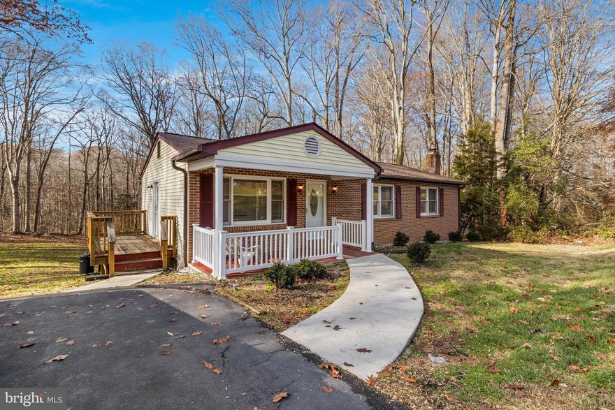 Welcome to this freshly painted brick rambler with 3 generous size bedrooms. The traditional floor plan seamlessly combines the kitchen and dining area. Recently updated bathroom fixtures. The main bedroom offers walkout access rear vinyl plank deck which overlooks the backyard and is surrounded by serene woods.  The unfinished walk-out level basement with a brick fireplace provides the potential for future expansion, storage space, or an additional rec area situated on a decent-sized lot. The home is equipped with a large vinyl plank deck that overlooks the backyard surrounded by serene woods. As a bonus two sheds to the left of the property convey as-is with the sale of the home!  Get here before it's gone!