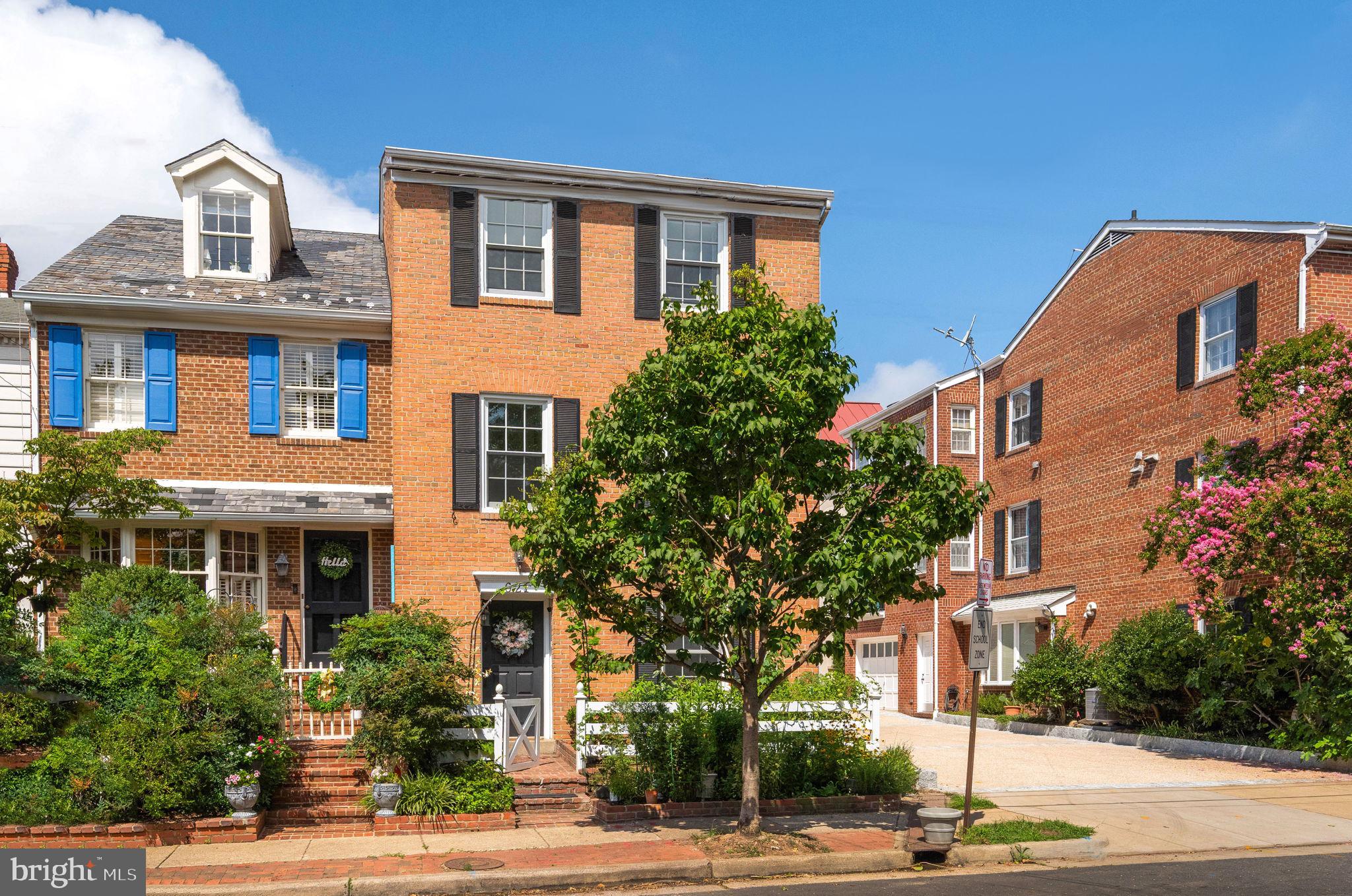Open Sat & Sun 1pm-3pm! Tucked away on a quiet block in the historic district of South Old Town, this three-level townhouse offers something special: both an edible front garden and a spacious English rear patio. You can enjoy outdoor living all year round, whether you're planting tomatoes in the summer or hosting firepit evenings in the fall.
The main level features a flexible layout with a bedroom, half bath, and family room that opens directly to the brick-walled private patio. Upstairs, the heart of the home has been completely reimagined: a 2022 kitchen renovation creates an open-concept flow with a center island, built-in storage, and generous space for both dining and lounging. The top floor offers three bedrooms and two full baths, including a sunny primary suite with a wall of closets and an updated ensuite bath.
You'll love how the three sides of windows keep the home filled with natural light and give corner unit vibes. And knowing that the major systems have been recently taken care of will give you peace of mind: Roof (2023), HVAC system (2025) and majority of windows (Pella, 2023). There is also attic storage for the seasonal extras.
Need dedicated parking? While the rear patio is a perfect entertaining space, the home also has easement rights on the shared driveway which provides the option to convert for off-street parking if desired.
Primely located, enjoy being a 10-minute walk to Jones Point Park, the King Street scene and Farmer's Market, waterfront parks, restaurants and local favorites like Balducci’s, Trader Joe’s, and Safeway. Dog lovers will appreciate the multiple nearby parks, and neighbors on this friendly St. Asaph block are known to host spontaneous “Sidewalk Schmoozes” when the weather is nice. Being six blocks from King Street means simpler street parking while maintaining easy proximity to the best of this vibrant community. This one is truly your Home Sweet Home!