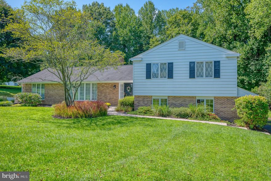 This four level split level home has been lovingly maintained by its original owners. Situated on  a picturesque 1.3-acre lot and located in the sought-after Rolling Green Community, this home has five bedrooms and 3.5 bathrooms.  You'll find hardwood flooring, crown and chair molding as well as a great floorplan. The eat-in kitchen is open to the family room with built-in shelves and wood burning fireplace. You'll find a laundry room with private exit along with a powder room conveniently tucked away. There is a formal dining room as well as an expansive living room - both with gorgeous hardwood flooring. You'll find a large brick patio and yard that backs to trees. Upstairs are four generous-sized bedrooms. The primary bedroom has two closets along with a renovated full bathroom. The additional bedrooms share an updated hall bathroom. The first lower level allows access to the oversized two-car garage. It has a bedroom that could be a great in-law or au pair suite with luxury vinyl plank flooring, kitchenette, closet and exit. The lower level is unfinished and open with plenty of storage. The Rolling Green Community Association is a voluntary non-HOA development. Membership dues are $150 annually. Rolling Green Community Association sponsors an active neighborhood watch program, provides a newsletter, hosts a community website, and many social events suitable for all ages. The community has a lake with a sandy area for having a picnic or launching a kayak.