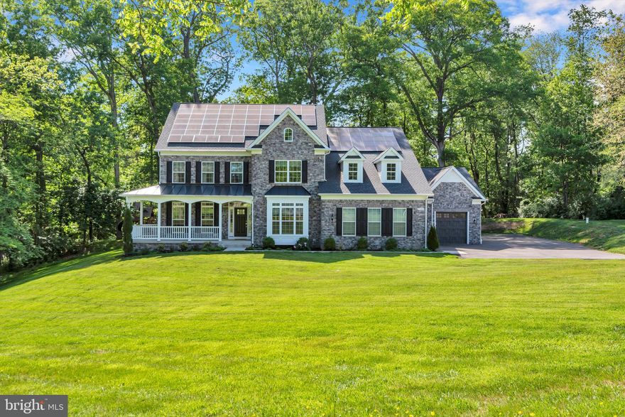 Welcome to this beautifully maintained custom-built estate situated on a picturesque and private 2.18-acre lot surrounded by mature trees and scenic views. Offering the perfect blend of luxury, comfort, and efficiency, this exceptional home is truly one of a kind. The main level features spacious formal living and dining rooms filled with natural light, along with an enormous gourmet kitchen complete with an oversized center island, Sub-Zero refrigerator, double ovens, dual beverage coolers, quartz countertops, designer backsplash, walk-in pantry, and abundant cabinet space. The stunning two-story family room showcases coffered ceilings and a gas fireplace. Also on the main level are a half bath, laundry room, and the first of two primary suites with a walk-in closet and attached full bath. Upstairs, retreat to the resort-style primary suite featuring a tray ceiling, private coffee bar, sauna, spa-inspired multi-head shower, double vanities, and spacious walk-in closet. Two additional generously sized bedrooms share a Jack-and-Jill bath, plus an additional full-size laundry room on the upper level. The finished lower level is an entertainer’s dream with a large recreation room and wet bar rough-in, fifth bedroom, full bath, media room and/or home gym, and extensive storage space. Enjoy the peaceful outdoor setting from the welcoming front porch or rear patio complete with fire pit and hot tub, perfect for relaxing or entertaining guests. Additional highlights include 72 solar panels dramatically reducing electric costs, elevator access to all three levels, 9-foot ceilings throughout, ceiling fans in every bedroom, extensive smart-home features & tech throughout, attached 3-car garage with mini-split system and EV charger, and detached storage shed. This remarkable property offers luxury living with incredible space, privacy, and thoughtful upgrades throughout. A true must-see.