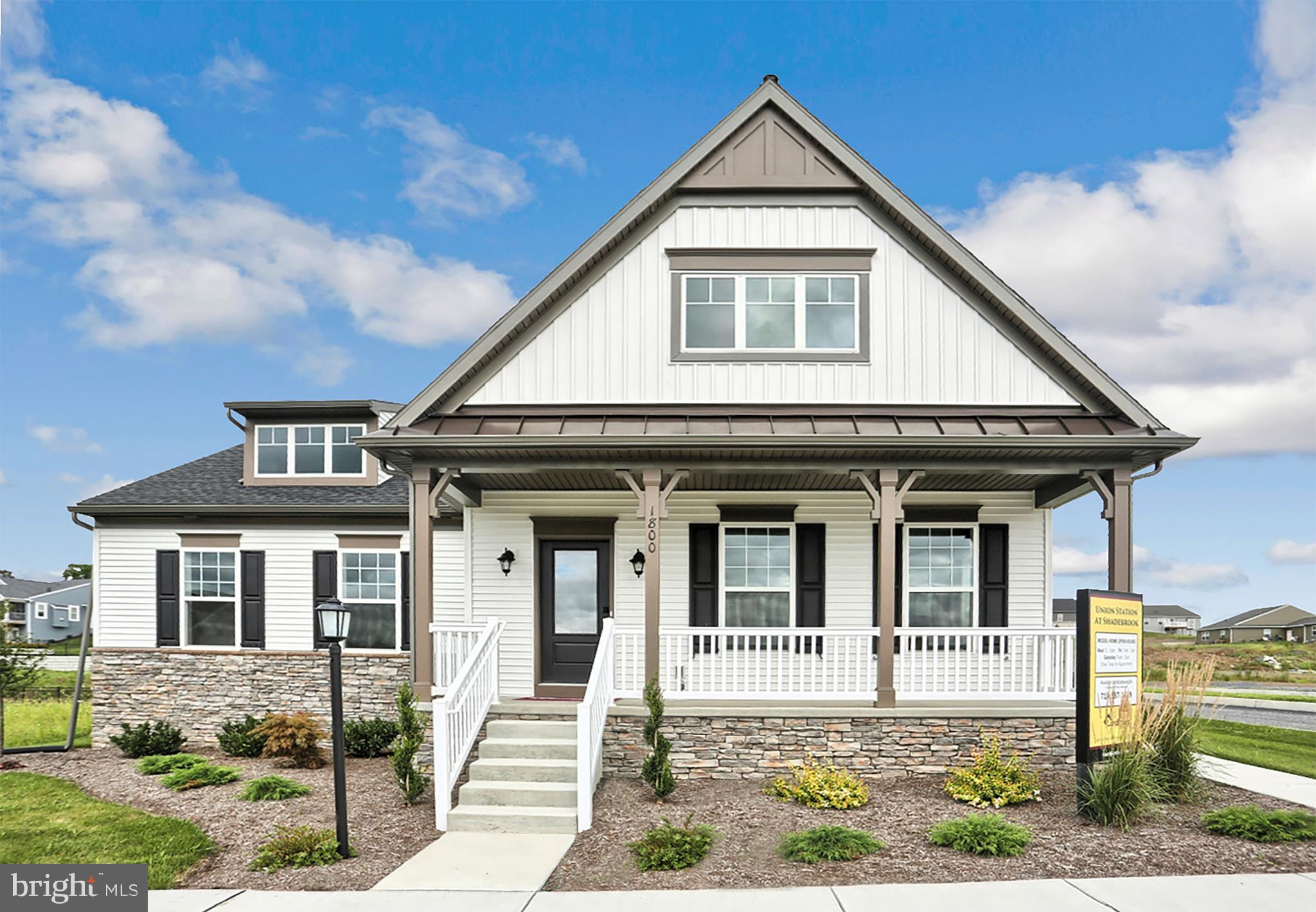 This 1.5-story home with welcoming front porch includes a 2-car garage. The garage opens to entry complete with built in lockers and access to laundry area. Stylish hardwood flooring in the foyer extends to the Kitchen and Dining Area. The Kitchen is accented with triple windows and includes stainless steel appliances, HanStone quartz countertops with tile backsplash, and attractive cabinetry with crown molding. Sunny Dining Area and Living Room off of Kitchen also include triple windows and sliding door access to the backyard patio. The Living Room includes a gas fireplace featuring stone surround and elegant shiplap to the ceiling. The Owner s Suite with ceiling trim detail includes an expansive closet and a private bathroom with double bowl vanity.