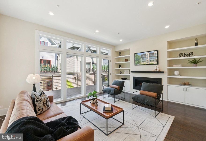 Welcome to 140 Winsome Circle, a sought-after end-unit elevator townhome in the acclaimed Grosvenor Heights community, built by award-winning EYA Homes. This one-of-a-kind home is the only residence in the community that sits directly next to a protected forested area, providing exceptional privacy, lush views, and a true connection to nature—just minutes from the heart of Bethesda

Thoughtfully designed and impeccably maintained, this four-bedroom, 3.5-bath home spans over 3,000 of above grade square feet across four levels, with ten-foot ceilings and a light-filled open floor plan.

The main living level impresses with 14 floor-to-ceiling windows with accompanying transoms which flood the space with natural light. The gourmet kitchen features a quartz island with pendant lighting and seating for four, and is outfitted with premium Bosch appliances, including a five-burner gas cooktop, convection oven, wall oven, and paneled refrigerator and dishwasher. An Aqua Crest kitchen drinking water filter adds a refined touch for everyday convenience.

The adjoining living and dining areas include custom built-ins, a gas fireplace with granite surround, and access to a private rear deck overlooking the trees. The main living level also includes a discreetly positioned half bath for added convenience.

Upstairs, the serene primary suite includes two custom walk-in closets and a spa-inspired bath. Two additional bedrooms, one of which features a charming Juliet balcony, share a full hall bath. A spacious laundry room with built-in storage and a utility sink completes the level. On the entry floor, a fourth bedroom or flexible office space with an en suite bath provides an ideal setup for guests or working from home.

The show stopping rooftop terrace is an entertainer’s dream, thoughtfully designed for year-round enjoyment. It features custom deck tiles, stainless steel cabinetry, a prep sink, a built-in Sedona gas grill with dedicated hookup, and a Viking beverage refrigerator ideal for cooking, serving, and relaxing outdoors. A wet bar and flat-screen TV (which conveys with the home) complete the space. For added comfort and versatility, the terrace includes a motorized awning for shade and a motorized privacy screen at the wet bar. Whether you're hosting a lively gathering or unwinding under the stars, this elevator-accessed rooftop offers the perfect blend of luxury and function.

Additional highlights include a private two-car garage, custom closets, whole-house AV wiring with Sonos, programmable Lutron lighting consoles, and elevator access to all four levels.

Ideally located, residents of Grosvenor Heights enjoy an active community and easy access to a wide array of nearby amenities. Stroll through the lush green walking paths of Fleming Park, the Bethesda Trolley Trail, and Rock Creek Trail. Minutes to Grosvenor-Strathmore Metro, Wildwood Shopping Center, Pike & Rose, and the Music Center at Strathmore. Convenient to I-495 and I-270, and districted into some of Montgomery County’s top-rated public schools.

140 Winsome Circle offers the rare combination of modern luxury, privacy, serene surroundings, and unmatched convenience. This is Bethesda living at its best.