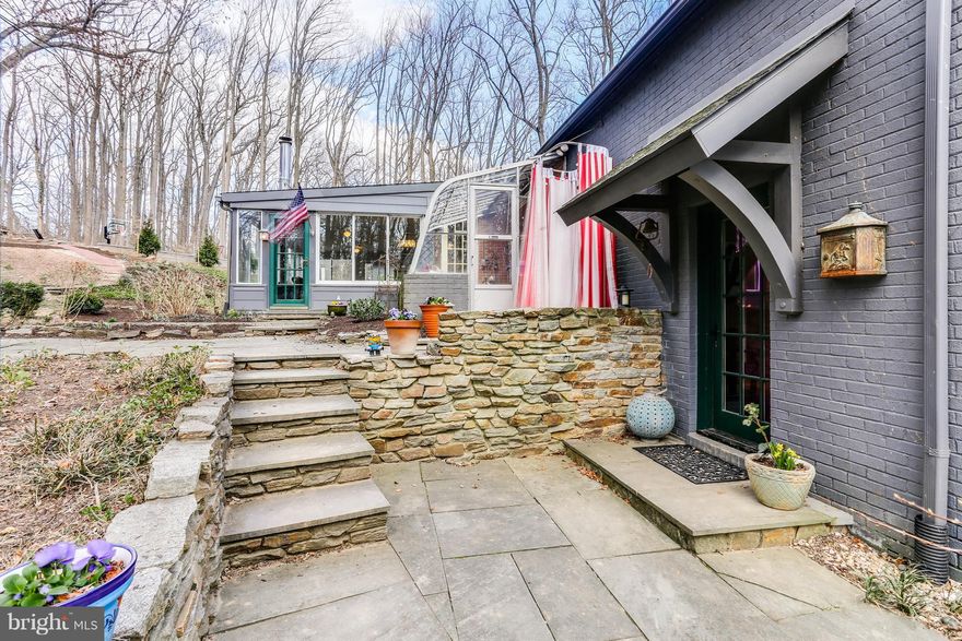 Special Woodland Retreat -  this distinctive home is a private oasis, complete with a beautiful master suite, updated baths, sun room, mudroom, and greenhouse. Two additional outbuildings offer extra entertainment space, and a personal gym/yoga studio .  The property also includes a new sport court, trails, stream, several patios, gardens, and a detached 3-car garage.