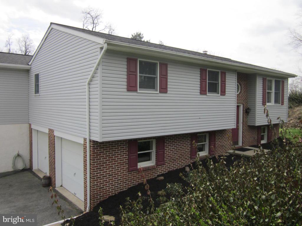 Country setting in Manor Township. Home has brand new carpet throughout, is handicap accessible, and has a pellet stove in rec room. Enjoy entertaining on the large deck w/awning. Plenty of extra storage in room off garage w/outside entrance for workshop,, utility shed, etc.http://www.LancasterOpenHouses.com/
