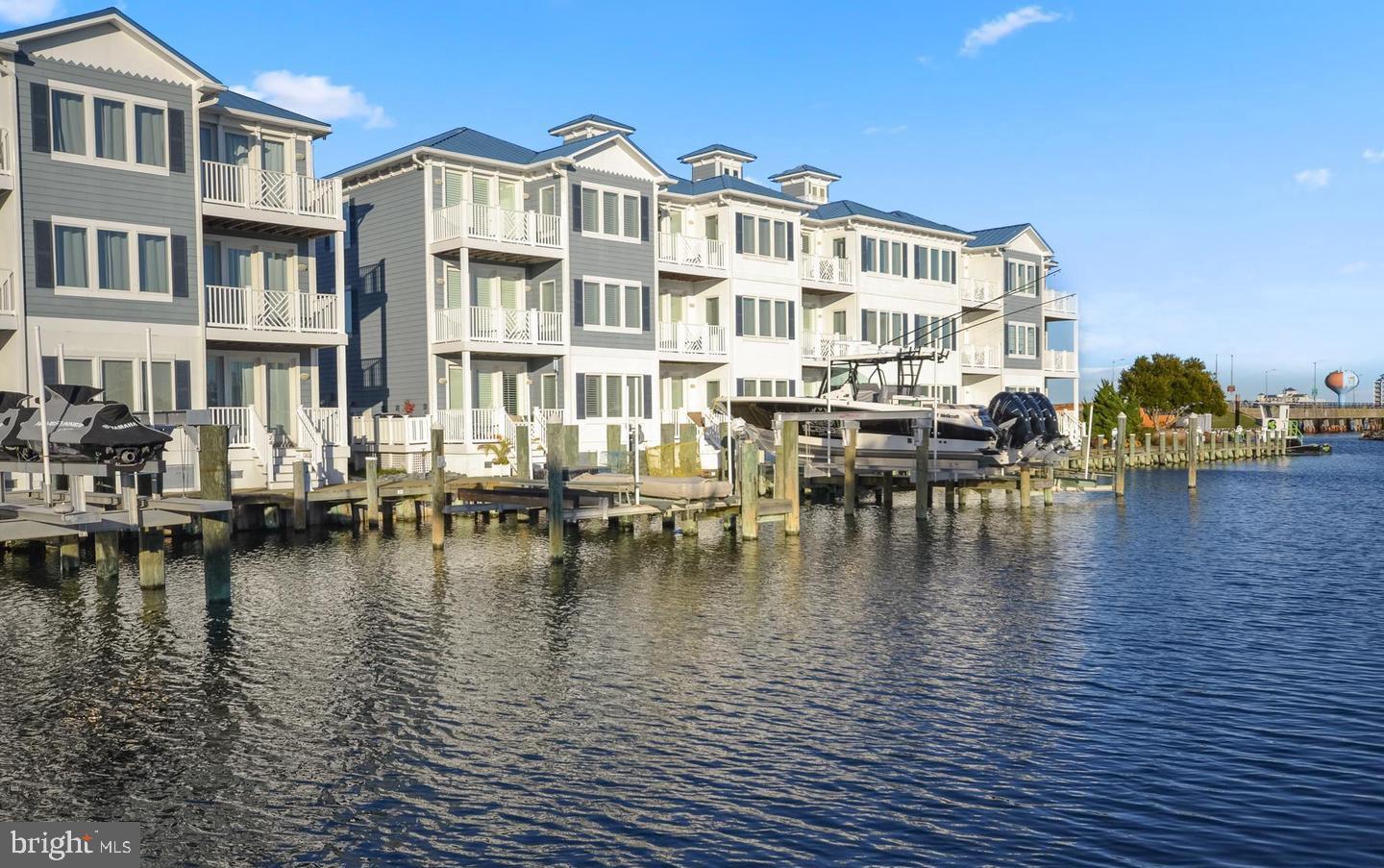 Luxurious custom coastal home with a 38ft boat slip, boat lift 7,000 lbs, beautiful views of the Marina. This unit was custom designed for original owner. This Stunning townhouse makes a perfect second home or primary residence. The first level boosts a second kitchen, family room, laundry, and bed and full bath for in-laws suite, or captain's quarters. This level leads out to a deck and down to the dock and boat. The second level boosts Primary suite with deck access with primary bath, laundry as well, guest bedroom and bath. Third level has Kitchen, Family Room, Dining, Gourmet Kitchen, Guest Room and Full bath. Home features: boat slip, custom glass door elevator, hardwood floors, newer HVAC 3rd floor, granite countertops, stainless steel appliances, custom window shutters, blinds, and window treatments, breakfast bar, decks on each level, great location to fishing center, Mickey Finns Restaurant, public transportation, perfect to view fireworks, easy access to the bay, community pool, epoxy coating on garage floor.
3-level layout with glass-door elevator
In-law suite (first level) with kitchen, family room, and deck access
Primary suite (second level) with private deck and luxury bath
Gourmet kitchen (third level) with breakfast bar, stainless steel appliances, and granite counters
Community pool and prime waterfront location near dining/boating amenities
Additional highlights include hardwood floors, epoxy-coated garage, and newer HVAC system. Positioned near Mickey Finns Restaurant and public transportation, this home combines luxury with coastal convenience. This is a stunning community, great location, and turn-key. Schedule your showing today.