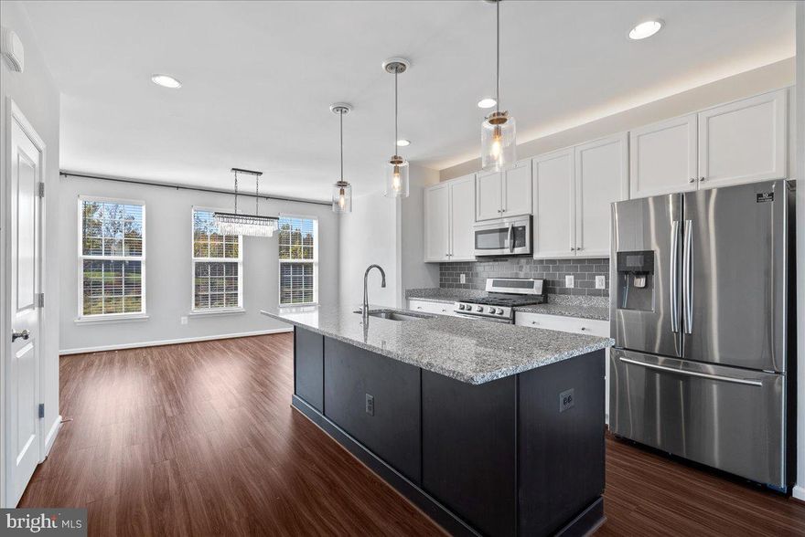 Bright and beautiful newer townhouse built in 2020, offering numerous upgrades and a thoughtfully designed layout! Enter on the main level, featuring a front-entry 2-car garage with epoxy flooring and built-in shelving. The spacious bonus/recreation room includes a full bath and opens to a fenced, manicured patio—perfect for relaxing or entertaining.

Upstairs, enjoy a chef-inspired kitchen with a gas stove, stainless steel appliances, and a separate dining area. The open-concept family room features an electric fireplace, an 85-inch mounted flat-screen TV, and access to a large deck ideal for gatherings.

The third floor showcases a luxurious primary suite with a spa-like bathroom, double-sink vanity, and glass walk-in shower. A generous walk-in closet provides ample storage for all seasons. Two additional bedrooms, a full bath, and a laundry room complete the upper level—one bedroom easily converts to a private home office.

Located in the sought-after Richmond Station community, this home is close to shopping, restaurants, and fitness centers, and offers a dog-friendly environment with its own dog park.

Please note: The home is rented unfurnished. Photos have been virtually staged for illustration purposes only.

Schedule your showing today!