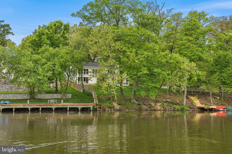 Set along the tranquil shoreline just off the scenic George Washington Memorial Parkway, this newly constructed waterfront retreat offers a rare opportunity to embrace a relaxed, resort-like lifestyle—only 15 miles from Washington, DC.

Positioned on a .60-acre lot with over 150 feet of expansive water frontage, the home captures sweeping, peaceful views that instantly shift the pace of daily life. With direct access to the Potomac River, mornings begin with calm reflections on the water, and evenings unwind with breathtaking sunsets—all just moments from the energy of the nation’s capital.

Spanning nearly 5,100 square feet, the residence is thoughtfully designed with BOTH a main level and upper level primary suite.  Six spacious bedrooms each with water views, ensuite baths, and custom closets, creating private retreats throughout the home. Wide-plank, sand-in-place white oak flooring and refined finishes add warmth.

At the center of the home, the chefs kitchen features custom cabinetry, GE Profile stainless steel appliances, a four-burner plus grill dual-fuel range, and a generous walk-in pantry. The adjoining family room, anchored by a gas fireplace, flows effortlessly to577 sq ft  deck with sleek wire railing—an ideal place to relax, entertain, or simply take in the stillness. The dining area extends naturally to outdoor living spaces and adjacent to the 140 sq ft  covered porch offering indoor-outdoor entertainment.  The oversized two-car garage  walks into a well-appointed mudroom.

Upstairs, a spectacular second primary suite spans over 1,200 square feet, offering a true private sanctuary. Dual custom walk-in closets and a spa-inspired bath with marble and porcelain finishes, heated floors, soaking tub, and designer lighting create a luxurious, restorative space. A large laundry room with built-in cabinetry, sink, and LG front-load washer and dryer adds everyday convenience. Three additional bedrooms with ensuite baths all with water views.

The lower level  is walk out and provides additional flexibility with a spacious recreation room, kitchenette, and a sixth bedroom or fitness space with a full bath—ideal for guests or extended stays.

Just steps away, a community boat ramp, picnic area, and waterfront deck invite easy, spontaneous enjoyment of the river. The surrounding area offers scenic trails and access to George Washington's Mount Vernon, perfect for walking, biking, and soaking in the natural beauty of the region.

This home delivers more than just luxury—it offers a lifestyle defined by calm, connection, and effortless waterfront living, all within close reach of the city.