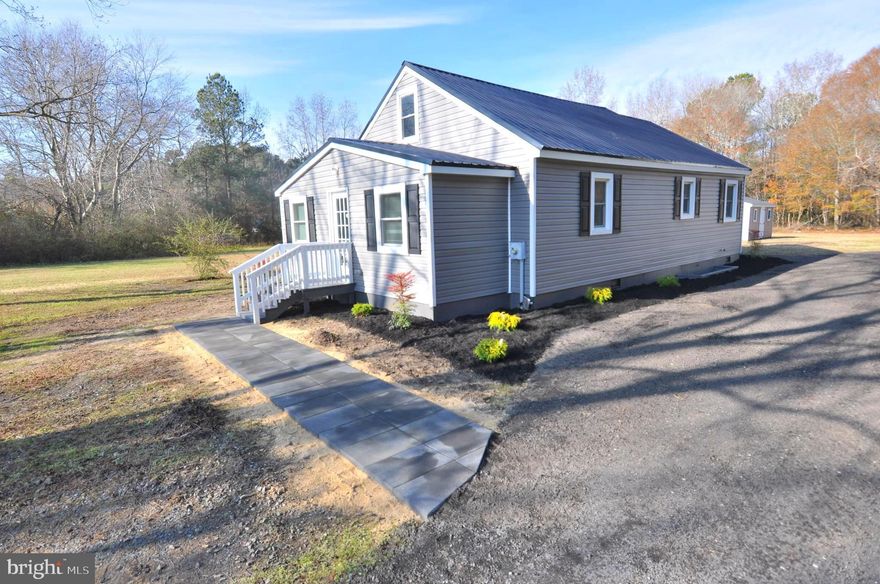 This elegantly renovated residence, first constructed in 1940, sits on a peaceful 1.6-acre lot in the countryside just beyond the boundaries of Pocomoke City.  The property has been thoughtfully and completely renovated, featuring a new metal roof, all-new vinyl siding, energy-efficient windows and doors, upgraded 200-amp electrical entrance all new wiring throughout. New modern flooring, fresh interior paint. New heat pump providing heat and air conditioning systems. New stainless-steel appliances. The attic is fully insulated (R-49) for year-round comfort. Side walls and crawl have new maximum insulation also. The residence offers a living room, eat in kitchen, mud-utility room, office-den two bedrooms and two full baths. Each bedroom providing a walk-in closet. A detached garage adds further convenience. There is another additional storage shed.  The spacious backyard is ideal for outdoor gatherings or gardening, while the totally new kitchen blends contemporary amenities with the home's original character—making it perfect for both relaxing and entertaining guests.