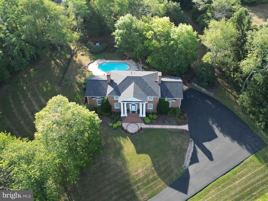Yes, Virginia, there is dream property just listed! Welcome to an architecturally designed 5,000 finished square foot all-brick estate (with gorgeous custom features inside & out, jaw-dropping hardscape and a gunite heated in ground pool).  Majestically situated on 2 lovely acres w/ no HOA, it’s located just 3 minutes from historic downtown Front Royal & 5 minutes from I-66 exit 13 (Linden)! From the magnificent columns on the covered front porch (turn around to soak up the mountain views) & stunning arched woodwork in the enchanting foyer to the 365 degrees of landscaping and fabulous hardscape, this showplace is truly one of a kind.  Be awestruck by the expansive two story foyer & great room–great room features splendid tiered recessed lighting, custom flouted wood panels w/ dental molding plus an impressive floor to ceiling remote activated gas fireplace w/marble surround & hearth). Entertain in the formal living room (featuring a faux vintage mantel) & dining room or enjoy meals in the spacious breakfast room. Property is on the market for the first time and is PRICED UNDER TAX ASSESSED VALUE with well over 100k IN RECENT UPDATES…..

CONSTRUCTION ELEMENTS:Solid oak hardwood flooring throughout main & upper level/Custom 20+ foot foyer & great room height (10 ft in remaining main level), 8 ft ceilings in upper level and 10 ft ceilings in lower level/Custom cast keyblocks & sills around windows/Transom, atrium & Palladian windows throughout/Grand custom milled oak curved staircase leading to an open upper foyer/250+ sq ft owner’s walk-in closet & exercise room with built ins (and access to two large attic storage areas) with dedicated Mitsubishi mini-split heat pump  (added in 2024 for $7k)/Architectural Millwork designed and installed custom trim (including multi-piece crown molding and thick bases throughout), built-ins/Multiple areas with raised seam copper roofing/Full house intercom system with radio/Paved driveway wired for future lit columned entry…..

RECENT UPDATES:Completely remodeled owner’s bath in 2025 ($30k invested in marble top vanities, walk-in tiled shower w/ marble flooring & shelving, dual shower heads, soaker tub, porcelain flooring & designer fixtures)/New roof in 2023 ($12k)/Dual zoned propane furnaces & air conditioners replaced in 2021 & 2022 ($12k)/Upper guest bathroom remodeled in 2022 for $18k (w/ new Kohler walk-in shower & sliding glass barn doors)/See documents section for more updates…..

KITCHEN DETAILS:Oversized marble top island (with sink and 5-person bar seating), marble backsplash, Corian counters, stainless appliances [GE Monogram refrigerator, newer GE Monogram convection microwave, KitchenAid dishwasher (2022), Jenn-Air double wall ovens, GE 5-burner glass cooktop], custom cabinetry features…..

LOWER LEVEL SPECIFICS: Enjoy the 1,500 sf finished rec room (at one time outfitted as a game room and featured on HGTV!)--it includes a 15 ft bar circa 1849 with a 1910 post office back bar flanked by mirrors & shelving. Another highlight is a floor to ceiling stone woodburning fireplace w/ walnut mantel (the bonus room could be a bedroom area for a future in-law apartment). The lower level guest room has a small window, large closet & is adjacent to a full bathroom. Pool guests can access the basement through double doors off the exterior brick foyer…..

POOL AREA FEATURES:Swimming depth=8.5 feet, new gunite (double plastered) in 2021, new filtration system in 2022, robotic pool cleaner, custom pool cover, easy-to-install child-proof fencing, expansive covered brick porch and electric wiring for a future pool house. The pool is accessed by two sets of alarmed double doors (from the great room & kitchen).....

OTHER NOTABLES:Laundry has utility sink, cabinetry, built in ironing board & access to pull down attic stairs/Nest thermostat & Ring doorbell convey/Breakfast room w/area perfect for a home office/reading nook……And yes, Virginia, there’s even more not listed!