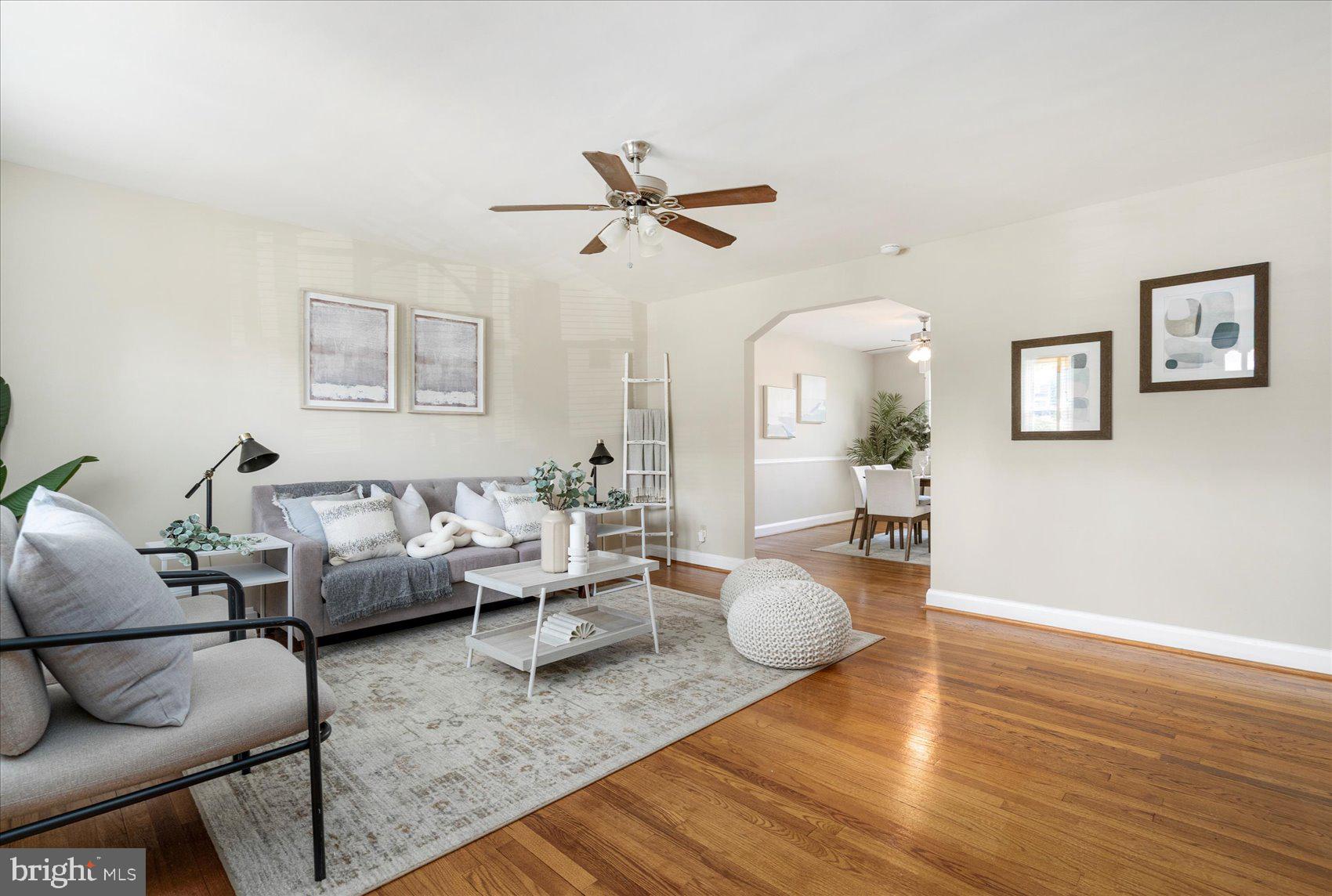 Beautifully refreshed 3BR/1.5BA brick Townhome located on a quiet street. Walk past a lush lawn and a shade tree on your way to the front porch of your forever home. Step into a home filled with tons of natural light, a soft color palette, and stunning hardwood floors on both the main and second floors. The main floor offers a large living room with an arched entry into the dining room featuring chair railings, and the kitchen. The kitchen is crisp and clean with newer appliances, and a large enamel sink. On the second floor are two sizable secondary bedrooms, a spacious primary, and a classic black and white tiled full bath. The lower level is finished offering additional living space with an open painted ceiling, a faux fireplace, a half bath, knotty pine paneling closets for storage, laundry hook up, and a walk-out to a covered patio in the fenced yard. From the kitchen step out onto a spacious balcony that overlooks a yard filled with green space and tons of possibilities. This home is move-in ready with so much to offer new homeowners and is located in close proximity to shopping, restaurants, and commuter routes. ** Solar panels are paid for!**