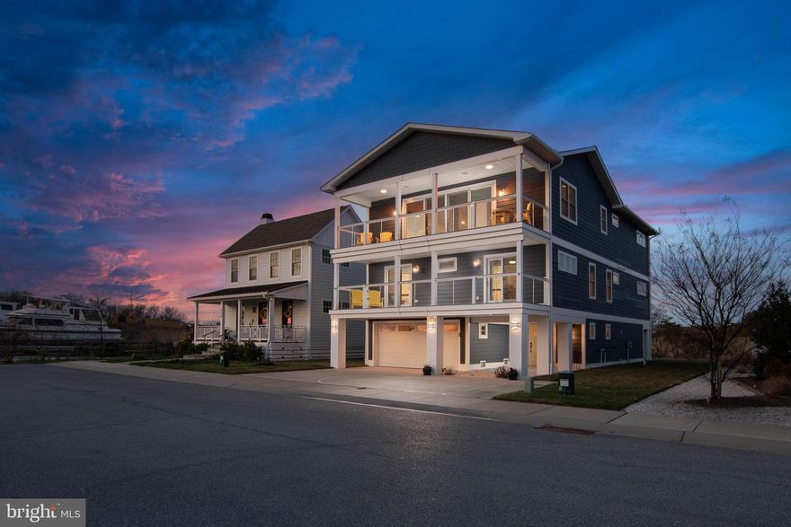 THE ULTIMATE COASTAL SANCTUARY! Welcome to a true masterpiece of modern seaside architecture in Anglers Nest! This meticulously designed 5-bedroom home offers an unparalleled lifestyle where panoramic vistas of the canal, salt marshes, and bay serve as your daily backdrop. The heart of the residence is the breathtaking top-floor great room, featuring soaring vaulted ceilings, wide-plank engineered hardwood floors, and a floor-to-ceiling shiplap fireplace. The gourmet chef’s kitchen is a showstopper, anchored by a massive waterfall quartz island and equipped with premium stainless steel appliances, designer cabinetry, and built-in wine refrigeration. Seamless indoor-outdoor living is achieved through expansive sliding glass doors that open to a large covered balcony, perfect for watching the boats return to the harbor.

The thoughtful layout provides ample space for family and guests, highlighted by multiple primary-style suites with spa-inspired bathrooms featuring custom tile work, frameless glass rain showers, and premium brass hardware. Additional amenities include a mid-level lounge with a dedicated wet bar and beverage fridge, multiple levels of composite decking, and a soft, airy coastal palette throughout. Perfectly positioned just steps from the tranquil Bay Beach and seconds from the docks of the Lewes Rehoth Canal, and historic downtown Lewes, this home represents a rare opportunity to own a front-row seat to the best of the Delaware coast.