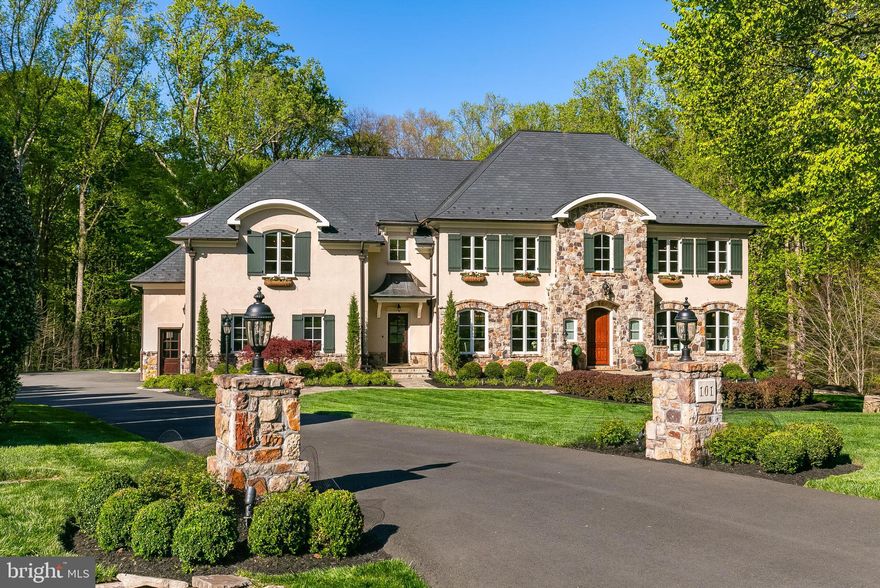 Nestled at the end of a serene cul-de-sac and backing to hundreds of acres of parkland with trails leading to and following the Potomac River, this extraordinary French Country custom home on over an acre offers an unparalleled blend of timeless European elegance, superior craftsmanship, and modern convenience. Every detail, from the meticulously selected materials to the thoughtful architectural elements, reflects a commitment to quality and refinement. The four-sides stucco-over-brick exterior, accented by a stone apron, is crowned by a 50-year faux slate roof w/copper snow guards, gutters and downspouts. The beautiful working wood shutters, English-imported flower boxes and 8’ solid arched front door with Rocky Mountain bronze hardware add to the homes abundant curb appeal. The private backyard offers tranquil wooded views, enjoyed from the expansive TimberTech deck. A cascading stacked-stone stairway descends to the pea gravel patio, perfect for al fresco dining and entertaining. Located off the recreation room and bar, it extends to a lush lawn ideal for backyard games—an entertainer’s dream. Inside, the grand two-story foyer captivates with a curved, floating cherry staircase. Italian-imported hand-painted iron balusters, tumbled marble flooring, and Dana Creath hand-forged lantern and wall sconces complete the striking entrance. Extensive millwork, substantial solid core doors and stunning wide plank, variable width sand-in-place American cherry flooring are among the numerous fine features of this home. The formal living room is further elevated by a French-inspired cast stone fireplace, while the dining room showcases an exquisite Niermann Weeks chandelier. The chef’s kitchen boasts a Wolf 48-inch range, Sub-Zero fridge, 2 Dacor warming drawers, Shaws farmhouse sink, Bates hammered copper veggie sink, furniture-grade Crystal Cabinetry and walk-in pantry. A thoughtfully designed island includes an entertainment area, breakfast bar and baking station. The spacious family room highlights a wood-burning stone fireplace. The office, features cherry built-ins and is surrounded by windows w/parkland views, allowing the occasional sound of passing horses to filter through open windows on warm days. The Owner’s Suite is a sanctuary, featuring arched French doors, a bay window sitting room, and marble-surround fireplace. The spa-like bath includes a clawfoot tub, intricately designed vanities, and a tumbled marble shower with dual showerheads. Two spacious walk-in closets with custom systems provide ample storage. With 9’ and 10’ ceilings and walls of windows, the walkout lower level is bright and welcoming. A custom-designed cherry bar, reminiscent of high-end luxury hotels, serves as the ultimate entertaining space. This level also includes a second family room, game areas, step-down gathering space w/a full building block stone gas fireplace, private gym, full bathroom and a 6th bedroom with French doors leading to a private patio. The home offers extra-wide upper hallways for a grand feel, and three stairwells for convenience. A masterclass in design, this one-of-a-kind home blends European elegance with modern luxury, offering a timeless retreat built for generations to enjoy, all tucked away in an exceptional neighborhood that is one of the area’s best-kept secrets. For golf enthusiasts, residents enjoy golf cart access to Trump National Golf Course, with the neighborhood seamlessly bordering the fairways. It delivers a sense of seclusion while providing convenient access to an array of amenities (private pool, playground and tennis courts) within a peaceful, beautifully maintained setting. All this and yet the home is just minutes from two Metro Stations, abundant shopping, dining & entertainment options, and a short drive to Dulles Int'l Airport—offering the perfect balance of retreat and connectivity. Floor plans & add'l info is in the docs section of MLS. Listing agent is the owner/seller.