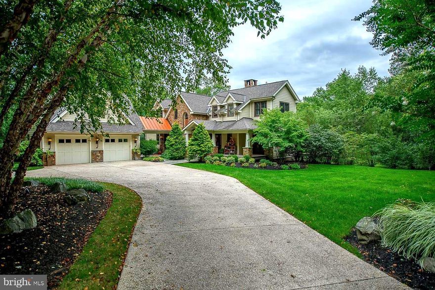 Set way off the road, perfectly nestled into nature- sits this custom boutique craftsman-style home that awaits the next incredibly fortunate buyer. Architect Rene Hoffman, along with the incredible design skills of the owner - created a truly unique home. The exterior-built from stone & Hardie plank - is warm & welcoming- it does not overwhelm you visually as you approach the house with grandeur- eventhough it is close to 6000 sf- the home is gracefully placed on the lot so not to overpower the trees, lawn, stream & pond that surrounds it- but-once you enter-the details & use of space is just spectacular.  Walk through the covered porch & gracious front door, the 1st thing you see is the centerpiece of this custom design -a four-sided stone gas fireplace that can be viewed from almost every vantage point on the main floor- your family &  guests will see a fire-glowing as soon as they enter.  Continue to your right & the dining room -which already has tons of natural light- gets to enjoy the 2nd view of the fireplace , on the next side is the two-story family room offering access to one of the decks &  showing off the 3rd vantage point of the fireplace. Look up to see salvaged beams & a warm wooden ceiling- it feels like you're on vacation everyday. The 4th side of the fireplace faces the gourmet kitchen. This open-concept cooking haven has island seating, a built-in banquette for morning coffee, and cabinetry & counter-top selections that withstand the test of time & will work w/ any style-trend, from contemporary to traditional. Off the kitchen is access to the 2nd deck, which looks over the fire pit, pond & so many lovely large growth trees. Also on the main level is a custom entertainment bar, great for setting up hors d'oeuvres, greeting & serving your guests & just simply, an easy spot to meet more storage needs. The last amazing space on this level is the master suite. Consisting of a dream bathroom, walk-in closet w/ custom built-ins, built-in dresser drawers, a spa-like bedroom - large enough for a king bed & a sitting nook & most importantly, personal access to the deck, with the privacy on this lot, you can wander out in your robe & have breakfast-no one can get a peek at you. Finally, this floor has a laundry rm w/ a pocket door closure & a powder room that will trap most of your guests inside, checking out all the cool details & special touches. Head to the 2nd floor & you'll find an open loft area currently set up w/a piano, an office space & built-in bookcases. This space is just so versatile! The 2nd level also has two more spacious bedrooms w/access to their own full baths- so when family & friends visit they'll have their own personal retreats. In one Br, the owner created a hidden napping closet for the grandkids -it can easily be converted back to a closet- it's just too cute. Head down to the lower level & you will find an open area designed as another living space/family room/playroom even though it is currently set up as a design center for the current owner's occupation- it has even more versatility than the loft on the 2nd level. Also on the ground floor is the 4th bedroom w/access to a full bathroom, great closet space &  daylight views of the yard. This whole floor could be used as an In-law or guest suite, an office & exercise area, or just as a 4th bedroom & sitting area w/easy backyard access. The home has an 3+car over-sized garage w/a covered breezeway into the house. There is also a bonus unfinished space over the garage that could be turned into a 5th bedroom, art studio - again-quite versatile. The setting is the perfect balance of trees, lawn, pond & creek- not too much maintenance- but just enough to feel private & nestled.  Sitting less than a mile from the Gwynedd Valley station,  just a short walk to the Green Ribbon trail & only minutes from restaurants & shopping- you can own this hidden retreat near every convenience!