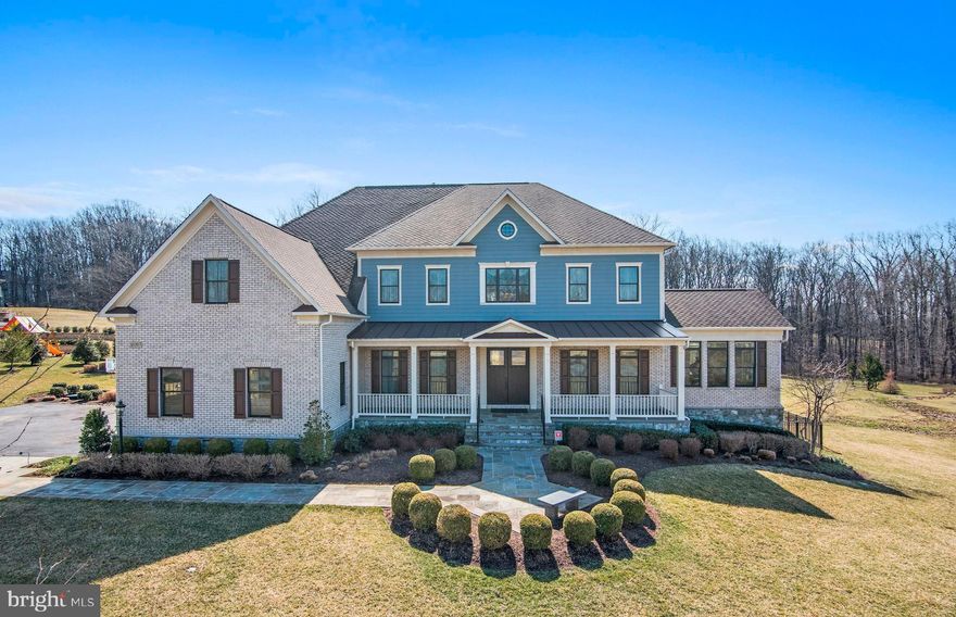 Features and amenities above and beyond are the hallmark of this fully upgraded, customized home and make it a true show stopper. Conveniently located in Ellicott City, this very special residence tells the story of a place where you can gather, create, retreat, or entertain.  Unparalleled in its use of the finest materials, and appointed with up-to-the-minute finishes, this incredible property is an expression of relaxed luxury both inside and out.Lighted stone Governor s pillars announce entry at the driveway, and a welcoming stone lead walk surrounded by landscaping escorts friends and family to the covered front porch. A pair of 8-foot doors with specialty trim baroque textured glass set the stage for the style and quality to follow. Inside, upgrades at every turn include hardwood floors in pewter gray, 10-ft plus tray and coffered ceilings and main level rooms embellished with exaggerated vestibule-styled case openings.  Generous interior rooms unfold within an open floor plan and a feature Jeldwin accordion door follows the same design precedent opening the family room to deck, creating a spectacular space that invites outdoor living and dining. Prep your favorite meals in a gourmet kitchen with a contrast island, Restoration Hardware pendants, stainless Viking appliances and custom height cabinets with under counter and kick lighting.Views of a professionally landscaped rear lawn and terraced stone walls surround a regulation tennis court and sand garden for sport and play.  Alongside the deck at the base of the cascading stair, a flagstone patio and outdoor kitchen with fridge and grill begin a full spectrum of entertainment possibilities incorporating music, media, and play inside.  Inside, the lower level walk-out patio is complemented by a full service kitchenette bar, remote blinds for full daylight windows, a wine room, cooler and racking for 1000 plus bottles and two bedrooms with a shared full bath.Retire at the end of the day in a gracious sitting room with a wet bar adjacent to the master suite trimmed with reclaimed wood on a feature wall and ceiling.  Treat yourself to a relaxing spa bath in the jetted tub, or a steam shower with rain head and body sprays. Two dressing closets and a signature bonus walk-in closet are outfitted with wardrobe built-in, drawers and jamb activated lighting to enhance your morning routine.  No detail has been compromised in presenting this home of distinction.  A once in a lifetime opportunity awaits here at 12057 Open Run Road.