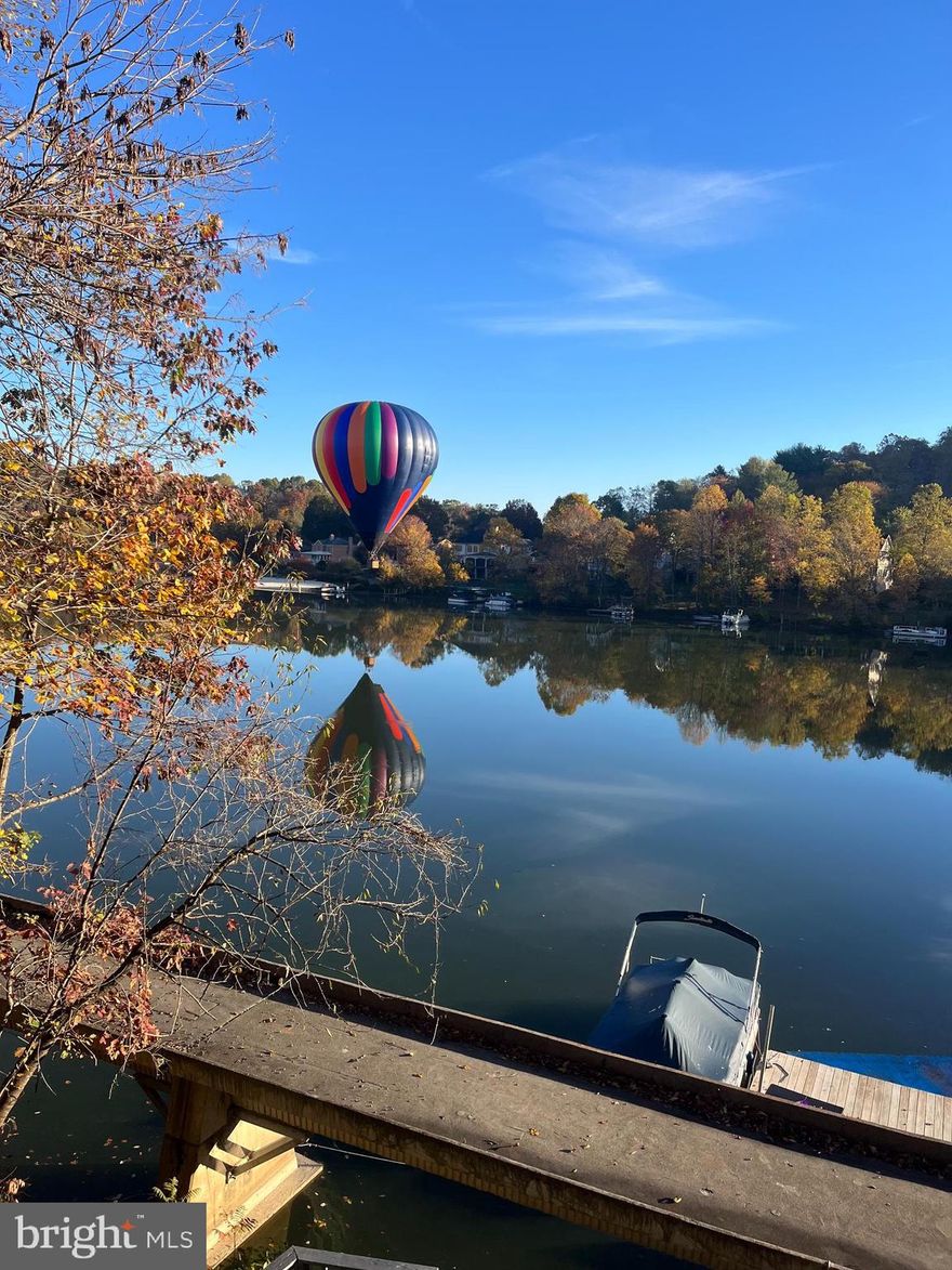 Welcome home to SUMMER 24/7.  This five bedroom, three level stunner is the pride of the neighborhood.  This is your excuse to say, "Sorry, lake plans!" 
Inside, you've got unique farmhouse charm, a side of Joanna Gaines, meets an  Instagram influencer. The  upgraded kitchen is ready for gourmet meals and casual get togethers.  A first floor formal dining room and dedicated office.  Yes, you can pretend you're being productive before heading out to your PERSONAL DOCK AND multi level decks over looking the lake.  Not many spots like this!
With three full levels, everyone gets their own space.  The owners suite is now located on the lower level with a recently  upgraded, hotel style bathroom and an amazing walk in closet.  
Upper level has 4 bedrooms, bring a guest, or two or even relocate the owners suite. So many possibilities.
The crown jewel is the private dock. Sit for hours enjoying the view on or off your boat with a fishing pole in hand. The lifestyle is hard to re create.
Steps to the community beach and ALL the fun. You will make a lot of new friends!!  What's not to love?  Did I mention the views? 
Welcome to Coldstream Drive.