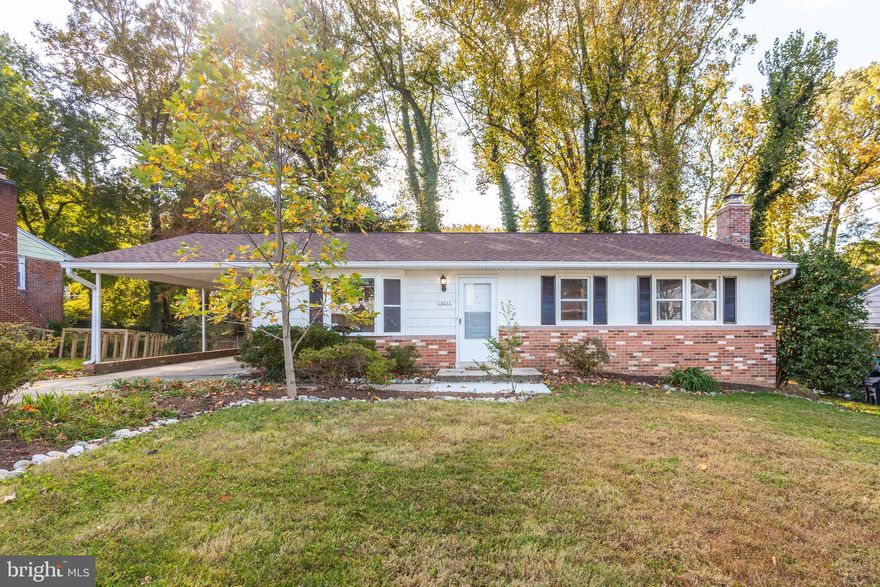 Welcome home! This 3 bedroom, 2.5 bathroom single family home is bigger than it looks! Pull in the long driveway and appreciate the large and professionally landscaped front yard. Stepping through the front door, you’ll discover the main floor features hardwood floors and new neutral paint throughout. The living room is bright and airy with a large picture window. Pass through to the dining room, with elegant wainscoting, chair rail molding, and a beautiful view through the wall-to-wall windows. The spacious kitchen is fresh and bright, with under cabinet lighting, a newer stainless steel fridge (2019) and newer oven with gas range top (2016). Down the hall you’ll discover the primary bedroom, which features an en suite bathroom with a ceramic tile walk-in shower and cabinet storage. Continue into the home and you’ll find two additional bedrooms with modern lighting fixtures and generously-sized closets. A second full bathroom with plenty of storage opportunities round out the main level of this home. Downstairs, an expansive rec room with brand new plush carpet (2022) and crown molding awaits! The generous size and layout of this room offer endless opportunities. It would be a great space to host your friends for the big game, enjoy some time with the family, or curl up by the brick fireplace with a good book. A vast laundry room includes newer washer and dryer (2016) and a gigantic storage area with built-in shelving. Enjoy the lush green scenery that the substantial backyard provides! This quiet, tree-lined property maintains plenty of privacy and serenity. The home’s sewer system hookup was replaced in 2019 and the brand new roof (2022) comes with a transferable 50 year parts & labor warranty, so you’ll never have to worry. Community amenities include a park with bbq pavilion, tennis courts, a soccer field, and a children’s play area. Minutes to Harris Teeter, Lidl,  Bowie Town Center, FedEx Field and Six Flags America. Quick access to  Rte 50, Rte 301, Annapolis Rd, Laurel Bowie Rd. Come see your new home today!