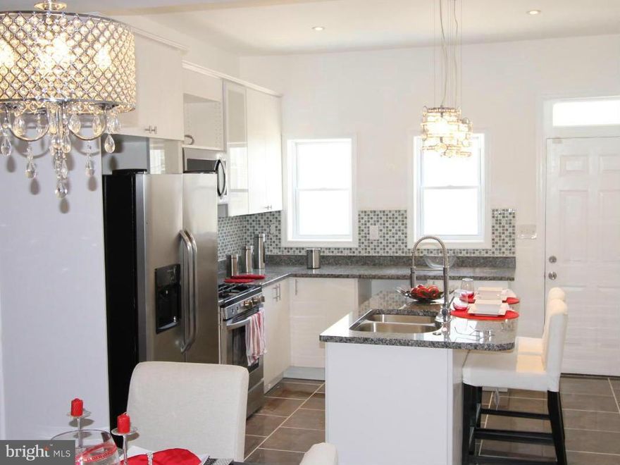 Stunning renovations glow with granite counters, SS appliances and an open floor plan that boasts modern living.  Three full baths are beautifully adorned.  You will be amazed at all of the space with this 3   4 bedroom home with a finished basement.  Two blocks to the park and close to Hopkins Hospital.  Agent has a financial interest in property.