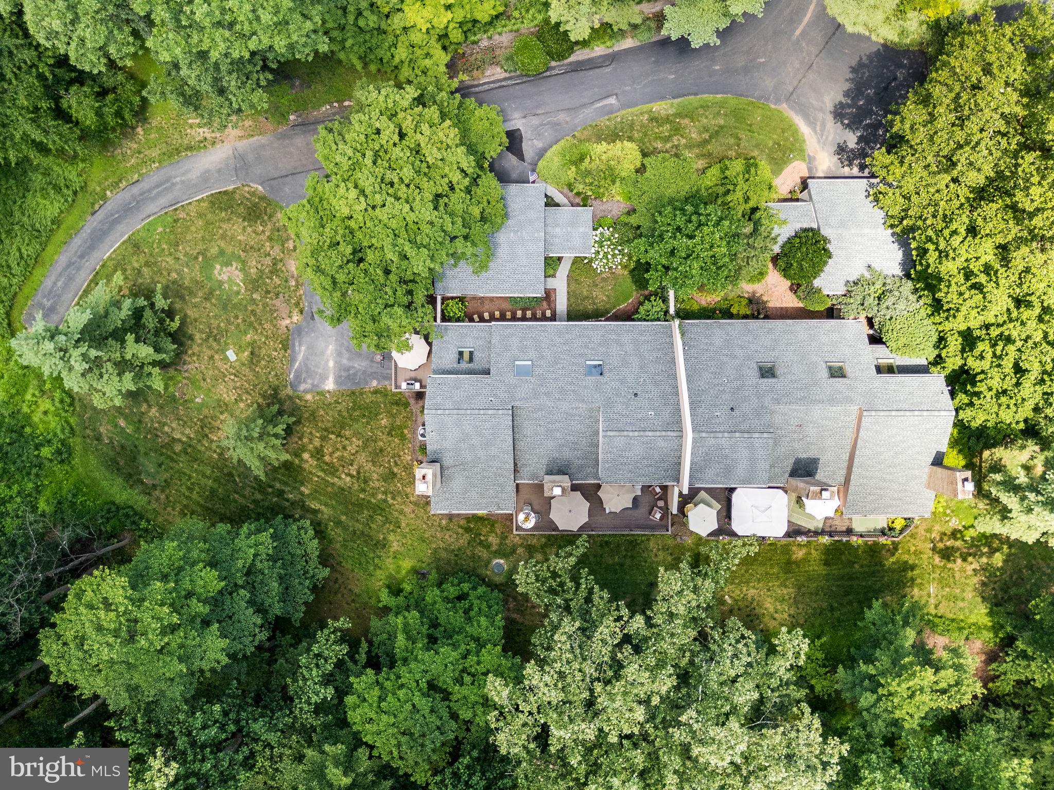 OPEN HOUSE this Sunday, July 27th from 1-4 pm. Toft Woods is a hidden gem carriage home located at the Newtown Square and Media border near Ridley Creek State Park in Upper Providence Township. This gorgeous home offers a 1st floor updated primary suite plus a daylight lower level with an in-law suite potential with its own one-car garage and private patio overlooking the woods. Enjoy the amazing scenic nature views and serenity you deserve at 50 Toft Woods Way yet only 5 minutes to shopping in Newtown Square. This is the home you have been dreaming about! Gorgeous updates throughout this lovely and meticulously maintained carriage home. 4 BR / 3.5 BA with a first-floor Primary suite plus a two-car and a separate one-car garage. This home is an amazing home with a relaxing, fenced-in and bright, and cheery courtyard plus a front covered patio. A welcoming two-story foyer with hardwood floors leads you to the gracious formal living room with a fireplace and stunning views of the wooded area behind this home. Toft Woods is comprised of 40 homes nestled on 40 acres in this low-density townhome community. The formal dining room is adjacent to the large gourmet kitchen with quartz countertops, cherry cabinets, and stainless steel appliances as well as seating at the kitchen island and room for a breakfast table near the pantry. One of the two decks is accessible via sliding glass doors for you to dine outside to enjoy the scenic nature views. The family room with a two-story stone fireplace with custom built-ins and a wet bar also offers you access to the other rear large deck for you to relax and or entertain family and friends. Also on the main level of this home is the first-floor primary bedroom suite, complete with a spa-like new bath with a large walk-in tiled shower and a stylish soaking bath. The second level features a large loft with skylights and custom shelving units in an area now utilized as an office. There are also 2 spacious bedrooms with large walk-in closets, plus a walk-in attic storage, and a full bath on this level. The finished lower level offers the opportunity to turn the entire level into a second living area for guests and or family, featuring a large media area, bedroom with large closet, full bath, dining area, plus another area for an office, workout area or additional bedroom. Rose Tree Media School District. Easy access from this level to a large patio overlooking the woods. The one-car garage is on this level as well. Located 5 minutes to Whole Foods and the many new restaurants and shoppes in Newtown Square as well as Trader Joe's and the restaurants and shoppes in Media where you can enjoy, " Dining under the Stars" and the many activities and concerts at Rose Tree Park, Tyler Arboretum and Ridley Creek State Park with its walking trails, fishing and horseback riding. My favorite paved trail is over the quaint bridge about 2 minutes from this home, where I enjoy walking my golden retriever along the Ridley Creek. Of course, she needs to enjoy a quick swim in the creek as well! Conveniently located to the Philadelphia Airport, Rt. 1, Rt. 476, and Rt. 95 for easy access to Wilmington as well. Click on the video camera icon to view the property video of this amazing home.