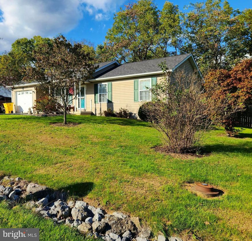 Welcome to Seneca Village - located just west of Hedgesville High School and adjacent to shopping, restaurants, medical, banking, and other amenities. This one-story home has 3 BR and 1 BA. There is an extra room that would work well as an office, flex room, guest room, or simply a storage area. The original garage area was modified by a previous owner to incorporate the finished flex room and still has plenty of storage for your lawn equipment/garden tools. A generous sized shed behind the house also conveys. The new owner will also benefit from the highly-rated Evolve water system  that conveys with the property. A new roof was installed just a few years ago. The backyard is spacious, fenced, and a great entertaining space complete with a large deck for grilling and visiting with friends. This home borders a vacant lot (3/4 acre)  which was allocated  for stormwater management purposes at the inception of development and can not be built on.  Want in a subdivision? Want a little elbow room? This home may be the right fit for you.