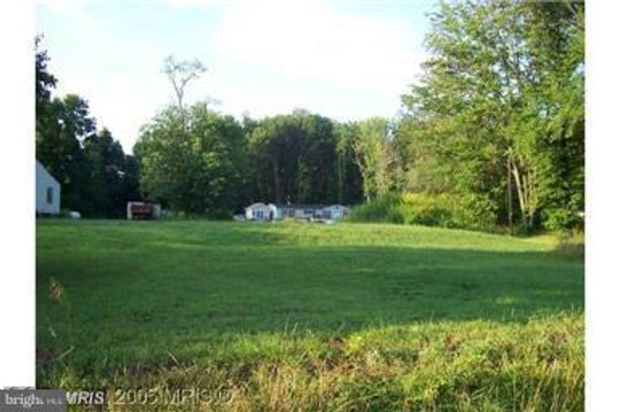 Split-Zoning - B3 (Commercial) and AG. Broad Variety of business uses are permitted in B3 Zoning - 15 gpm well drilled in 1999 - Sand Mound Septic System installed in 1999 which is approved for 3 BR home and small business use. Existing 4 BR * 2 BA Mobile Home and storage shed are included. The mobile home is set on piers and not on a full foundation.   The electricity is not in service in the mobile home. Bring a flashlight. See MRIS docs for well/septic/zoning info.