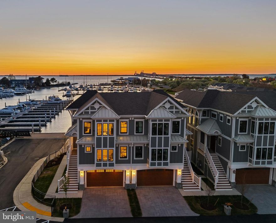Welcome to Sunset Wharf, a refined waterfront enclave set within the picturesque Bay Bridge Marina, where coastal living is defined by sweeping views and effortless sophistication. This fully completed residence is one of just a select offering within the initial collection of three buildings, each thoughtfully designed with only two residences each, creating an intimate and private setting along the water’s edge.

Inside, the home unfolds across three levels with a thoughtfully designed four bedroom, four bath layout that offers both flexibility and comfort. A private bedroom and full bath on the entry level provide the perfect space for guests or a quiet home office. The main living level is designed for seamless everyday living and entertaining, highlighted by a warm and inviting living room with a gas fireplace that adds both comfort and ambiance. The upper level features two additional bedroom suites, including a serene primary retreat complete with its own gas fireplace. An elegant touch that enhances the sense of relaxation and retreat.

Expansive windows frame captivating views over the marina and out to the Chesapeake Bay, filling the home with natural light and creating an ever-changing backdrop of boating activity and open water. As the day winds down, the setting truly comes to life with breathtaking sunsets that paint the sky and reflect across the water. An experience to be enjoyed from both the interior living spaces and outdoor areas.

High-end finishes and a modern, open-concept design elevate the interiors, while the beautifully appointed gourmet kitchen and well designed baths enhance both form and function. Every detail has been curated to deliver a low-maintenance, lock-and-go lifestyle without compromising on luxury.

Ideally positioned within walking distance to waterfront dining, including Libbey’s Coastal Kitchen & Cocktails and Knoxie’s Table, residents also enjoy immediate access to marina amenities, scenic walking paths, and the relaxed rhythm of life on the Bay. Sunset Wharf offers a rare opportunity to own a newly completed residence in a thoughtfully designed waterfront community where every day feels like a getaway. Welcome Home!