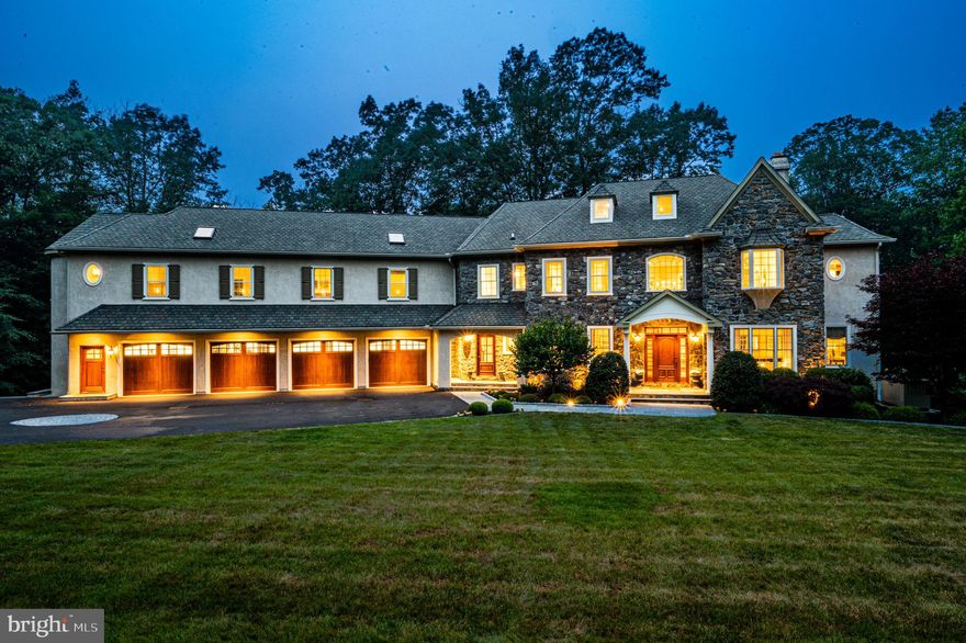 Welcome to the extraordinary world of this impressive colonial manor home. Tucked away down a long, private drive, this oasis offers unparalleled privacy and breathtaking landscaping that will leave you in awe.  Prepare to be amazed as you step inside this fabulous house designed for grand entertaining and luxurious living.  Approaching the property, you'll be greeted by meticulously manicured grounds and lush greenery, creating a picturesque setting. The elegant facade of the colonial manor exudes timeless charm and sophistication, setting the tone for the exquisite experience that awaits within.  As you step through the front door, you'll be welcomed into a grand center hall that sets the stage for the gracious living spaces that unfold before you. The main part of the home boasts a seamless flow, ensuring that every room is designed with entertainment and comfort in mind.  Indulge in the exquisite details that make this home truly exceptional with a range of stunning features that enhance its elegance and comfort.  From hardwood floors to crown mouldings, wainscoting, and radiant heat floors, every aspect has been thoughtfully designed to create the ultimate living experience.  The formal living room and dining room offer an elegant backdrop for hosting sophisticated gatherings and intimate dinners. A butler's pantry ensures seamless service, while adding a touch of practicality. The fireside family room, open to the state-of-the-art kitchen and breakfast room, provides a warm and inviting space for relaxation and casual get-togethers.  An enclosed barbecue porch, designed for year-round grilling, invites you to enjoy the outdoors in any season. Adjacent to the porch, a spacious deck extends the entertainment possibilities, offering a delightful space for simply savoring the tranquility of the surroundings.
For those seeking a quiet retreat or a dedicated workspace, the private study is an ideal sanctuary. Complete with custom built-ins, this room offers a serene environment to focus and create. The main staircase leads to a charming sitting area off the master suite.  Prepare to be enchanted by the luxurious master bedroom suite, a true haven of comfort and relaxation. This expansive retreat boasts a stunning bedroom, a master bath with lavish amenities, dressing area with custom make-up vanity, and an enormous custom closet with island and accent window.  The remaining section of the 2nd level features 3  bedrooms  and 2 baths designed to provide comfort and privacy, and an enormous bonus of this exceptional property is the attached in-law suite or home office. This self-contained space features two additional bedrooms, a full bath, a kitchenette, and a separate entrance off the 4-car garage. It offers flexibility and convenience for accommodating extended family members, guests, or an in-home office set up and yoga room as it is currently used.  The lower level of the house offers a fully finished space that is perfect for entertainment.  A large media/theater room, bar area, game room with access to the putting green and hot tub, an exercise room, and a recording studio create a haven for leisure and enjoyment. Car enthusiasts will appreciate the spacious 4-car garage, providing ample room for vehicles, storage, and work space.  Discover the ultimate peace of mind in this remarkable residence, where your comfort and security are ensured throughout all four seasons. One of the standout features of this home is the whole house generator, providing uninterrupted power supply and eliminating worries during unexpected outages. This remarkable residence presents an extraordinary value, combining luxurious amenities, versatile living spaces, and a separate in-law suite or home office—all in one magnificent package.
Don't miss your chance to own this architectural gem that offers privacy, luxury, and endless possibilities. Easy access to all major roadways and a quick drive to downtown Wayne, Villanova, and all local trains