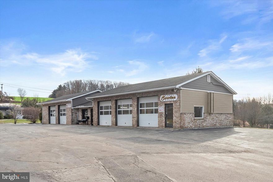 This 10.4816-acre commercial property features C-3 zoning, the highest commercial zoning classification in Carroll County, allowing for the widest variety of commercial uses. The site offers full frontage along Hanover Pike from Ebbyvale Road onward and benefits from strong traffic exposure of approximately 22,000–27,000 vehicles per day (VPD).
The property is improved with five buildings totaling approximately 16,000 SF and is currently operating as a used car dealership, tire shop, inspection point, service and repair facility, and body shop. Improvements include a two-level main office and showroom building with administrative offices for sales, finance, management, and tag/title operations; a 7-bay service and tire facility with alignment equipment, customer waiting area, office space, and upper-level storage or parts area; a separate office/support building with front and rear access and bathroom facilities; a fully equipped body shop with four oversized bays capable of accommodating ambulances or larger vehicles, with heating installed; and an additional three-bay service building suitable for car wash or light service use. The site also offers parking capacity for 200+ vehicles.
Permissible uses under C-3 zoning may include a strip retail center with an anchor tenant, a gas station with a convenience-oriented pit stop concept (such as Royal Farms), branded auto dealerships including Toyota, Honda, Chevrolet, Ford, and others, or senior and assisted living facilities, which are in high demand in the area. The property’s size, zoning, and location allow it to serve both the Carroll County and Hanover markets and offer immense long-term potential.