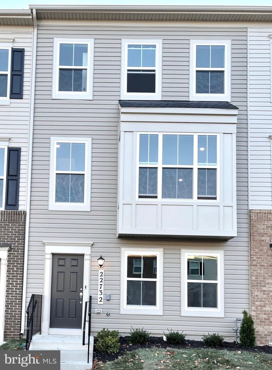 Welcome to 22372 Tater Place, a beautifully maintained Cambridge Model townhome built by Lennar in 2021, located in an amenity-rich community. This impressive home offers four bedrooms, three full bathrooms, two half bathrooms, and a fully finished fourth-level loft, which can be used as an additional bedroom or home office. The brick-front exterior and two-car rear-load garage add to the home’s appeal. Inside, the open-concept main level features abundant natural light and luxury vinyl plank flooring throughout the lower recreation room and main level. The gourmet kitchen is highlighted by gray cabinetry, granite countertops, a center island, subway tile backsplash, stainless steel appliances, and a large pantry, with a dining area that opens to a composite deck through sliding glass doors. The upper level includes a spacious owner’s suite with a walk-in closet and a luxurious en-suite bathroom with double vanities, glass shower, and private water closet, along with two additional bedrooms, a full hall bath, and a convenient laundry room. The fourth-level loft is fully finished with a powder room and access to a private terrace. The community offers outstanding amenities including a pool, clubhouse with gym, dog park, tot lot, and ample guest parking, and is conveniently located minutes from I-270, Clarksburg Premium Outlets, shopping, and dining. No pets allowed. Minimum two-year lease required.