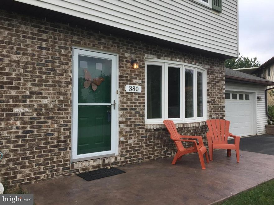 Semi-detached partial-brick front home, lives like a detached home in a tightly-knit community.  Large homesite with a 2-car oversized garage w/attic storage, high ceilings, insulated garage door.  The recently remodeled kitchen, the heart-beat of any home, offers Quartz countertop, SS appliances (gas stove), ceramic tiled backsplash, wood flooring, and wainscoting in both the kitchen and adjacent dining area. Possible first floor bedroom.