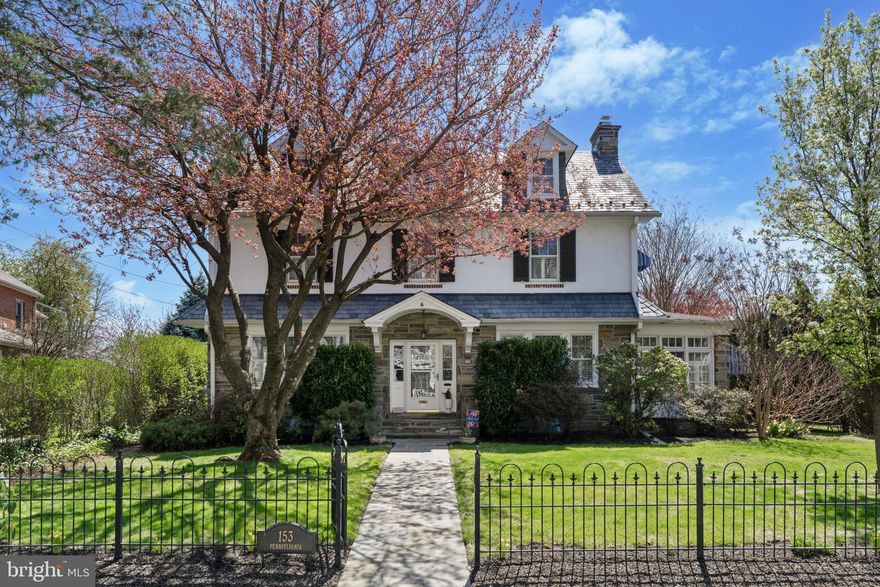Welcome to 153 Pennsylvania Avenue, a beautifully maintained stone colonial that effortlessly blends timeless elegance with modern comfort. Located in the highly acclaimed Lower Merion School District (Black Rock MS), this exquisite 5-bedroom, 3.5-bath residence offers the perfect fusion of classic charm and contemporary luxury.
From the moment you arrive, you’ll be captivated by the home’s serene curb appeal, nestled in a vibrant neighborhood celebrated for its annual block parties and strong sense of community. A custom wrought iron fence and slate walkway lead you to an inviting grand foyer, where you’ll find stunning black walnut hardwood floors, intricate wainscoting, and custom window shutters that enhance the home’s refined character.
The spacious living room, anchored by a cozy gas fireplace, is ideal for relaxing or entertaining. Just beyond, a beautifully renovated four-season sunroom welcomes abundant natural light, offering a tranquil retreat year-round.
At the heart of the home lies a gourmet kitchen that’s as functional as it is stylish. Designed for the culinary enthusiast, it features marble countertops, custom cabinetry, a 6-burner BlueStar gas range, and premium stainless steel appliances. A large breakfast bar, elegant backsplash, and rich hardwood floors flow seamlessly into the bright and airy dining area—creating the perfect space for meals, celebrations, and everyday gatherings. The kitchen also includes a built-in mini fridge and dry bar, perfect for entertaining and extra convenience.
Adjacent to the kitchen, a private home office or study overlooks the scenic backyard—an ideal space to work or unwind. A tasteful powder room adds convenience for guests.
Upstairs, the primary suite offers a spa-inspired retreat, complete with two large closets and a luxurious ensuite marble bath featuring double sinks and an oversized double shower. Three additional generously sized bedrooms with ample closet space, a stylish marble-tiled full bath, and a conveniently located second-floor laundry room complete this level.
The third floor adds even more versatility, with two private bedrooms—perfect for guests, teens, or home studios—each with walk-in closets and a shared marble bath with a spacious walk-in shower.
The newly finished basement offers endless possibilities. Whether you envision a media room, game room, or cozy lounge, this space is made for entertaining. It also includes a charming wine cellar—perfect for storing and sharing your favorite vintages—plus a large storage area and dedicated workshop for hobbies and projects.
Step outside to the expansive slate patio, a peaceful outdoor sanctuary framed by mature hedges and specimen trees. It’s an ideal setting for alfresco dining, entertaining, or simply enjoying nature’s beauty. A detached 3-car garage and an oversized private driveway provide ample parking for family and guests.
Ideally located just blocks from top-rated restaurants, coffee shops, boutiques, the Bryn Mawr farmer’s market, summer concerts at the gazebo, the Bryn Mawr Film Institute, and the R5 train line to Center City—this home offers unmatched convenience and a true Main Line lifestyle.
With low taxes, exceptional updates, and thoughtful details at every turn, 153 Pennsylvania Avenue invites you to settle in, spread out, and enjoy a life of comfort, community, and refined living.
